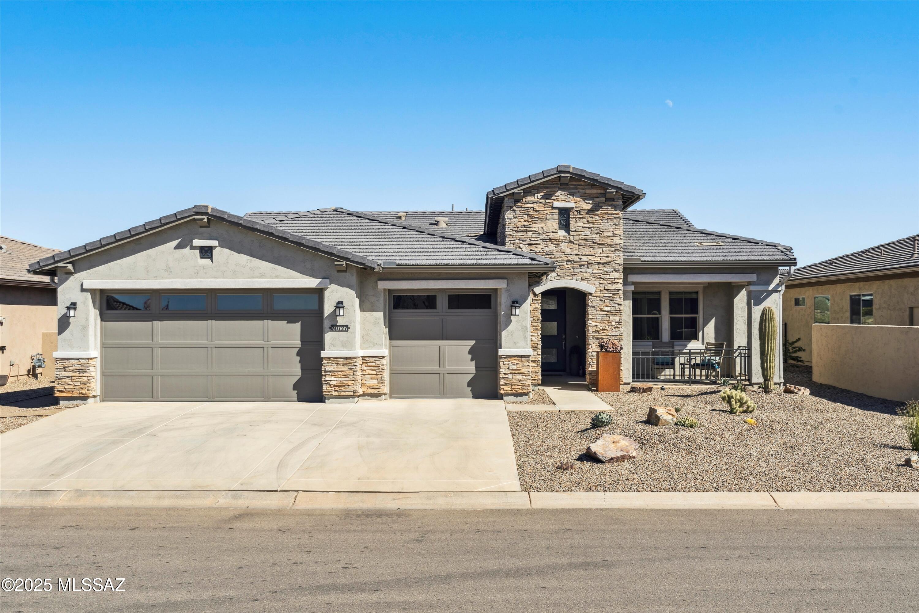 Experience luxury living in this stunning home at Saddlebrooke Ranch, a premier 55+ community! This beautifully upgraded & expanded Avalon model  features a gourmet kitchen with GE Monogram appliances, a GE Profile wine center, Blanco farm sink & upgraded granite countertops throughout. Entertain effortlessly with floating dining room cabinets, under-cabinet lighting, and a 16' patio glass slider for seamless indoor-outdoor living. The spa-like master bath boasts a curbless walk-in shower, rain shower, and dual hand showers for comfort and Custom built-ins enhance every closet, including an expanded master closet with laundry access. A California Closets Murphy bed in the guest room & French doors with shades in the den provide flexibility and privacy. (Click for more details) The extended 4' garage features an epoxy-coated floor, insulated ceiling, sink, and cabinet bank. Most light switches are dimmable, with ample built-in overhead and accent lighting. Outdoors, enjoy a travertine patio, retractable shades, and a gas fire table, perfect for stargazing from the hot tub spa. The backyard features a fountain, gas BBQ hookup, and low-maintenance landscaping with visibility and snake deterrent fencing. Sunrises illuminate the private backyard overlooking landscaped arroyos, while sunsets grace the front porch with stunning Catalina Mountain views. This home is a must-see for those seeking luxury, privacy, and comfort in Saddlebrooke Ranch!