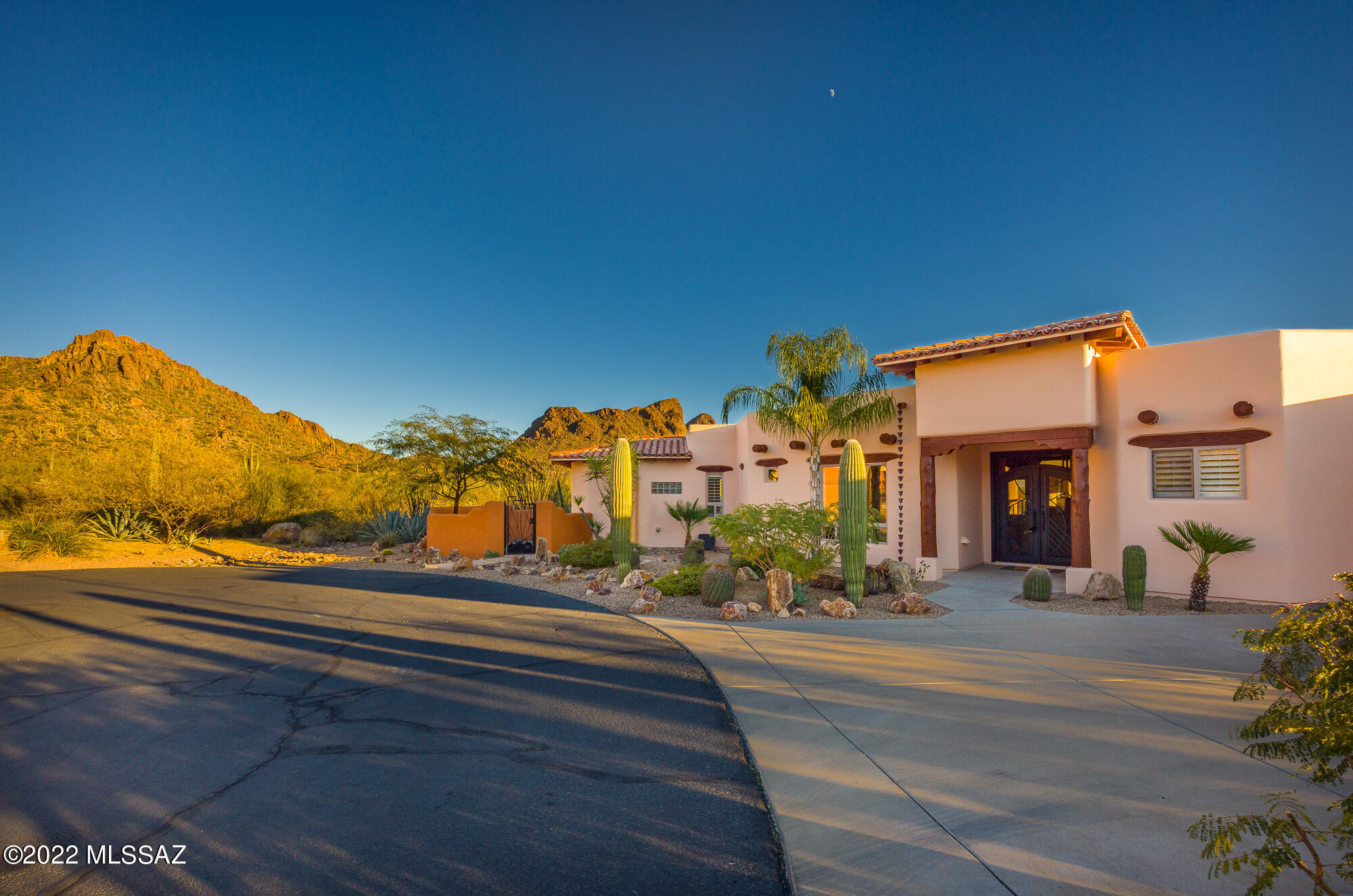 You'll love this spacious custom-built home tucked  inside the gated community of Tucson Estates bordering beautiful Tucson Mtn Park. The well maintained & charming Sante Fe style home is situated at the end of a cul-de-sac & boasts wonderful curb appeal and outstanding 360 degree views!  Custom double iron front door leads to the charming home that features true Southwest touches including authentic hand scraped pillar posts & Viga beam ceilings. Kitchen with custom knotty alder cabinets set off by thick rough edged granite & old world charm. Kitchen open to the Great room boasting amazing views, cozy beehive fireplace for cool evenings and built-in display shelves. Expand your living space to enjoy the Tucson lifestyle & amazing views on multiple patios  including a large screened porch! Enjoy having two primary bedroom suites each with luxurious en-suite baths with jet tubs, oversized travertine tile showers and rough edged granite double bowl vanities. Den within primary bedroom 1 is perfect  space for exercise room or quiet sitting room.  Primary bedroom 2 includes a Murphy bed with side bookcases. Den off the foyer is great space for a home office.  Pride of ownership is evident with freshly painted exterior, re-coated roof, extended termite warranty and sparkling clean interior. Other features include whole home water conditioner and central vac system, wood plantation shutters, 3 zone HVAC with Nest thermostat, built-in BBQ. Tandem 3-car garage allows plenty of room for storage and a workshop. Located within a gated community with community pool, spa, rec center, tennis courts & pickle ball. Pool/spa were being re-plastered at the time photos were being taken. Enjoy an active Tucson lifestyle with access to multiple hiking and mountain bike trails with Bob Cat Ridge, Cat Mountain and Golden Gate Mountain all around you. Location is in close proximity to the Desert Museum, Old Tucson & Gates Pass. RV rental space available nearby for $200/year. Make this spacious and very special home your own home sweet home!