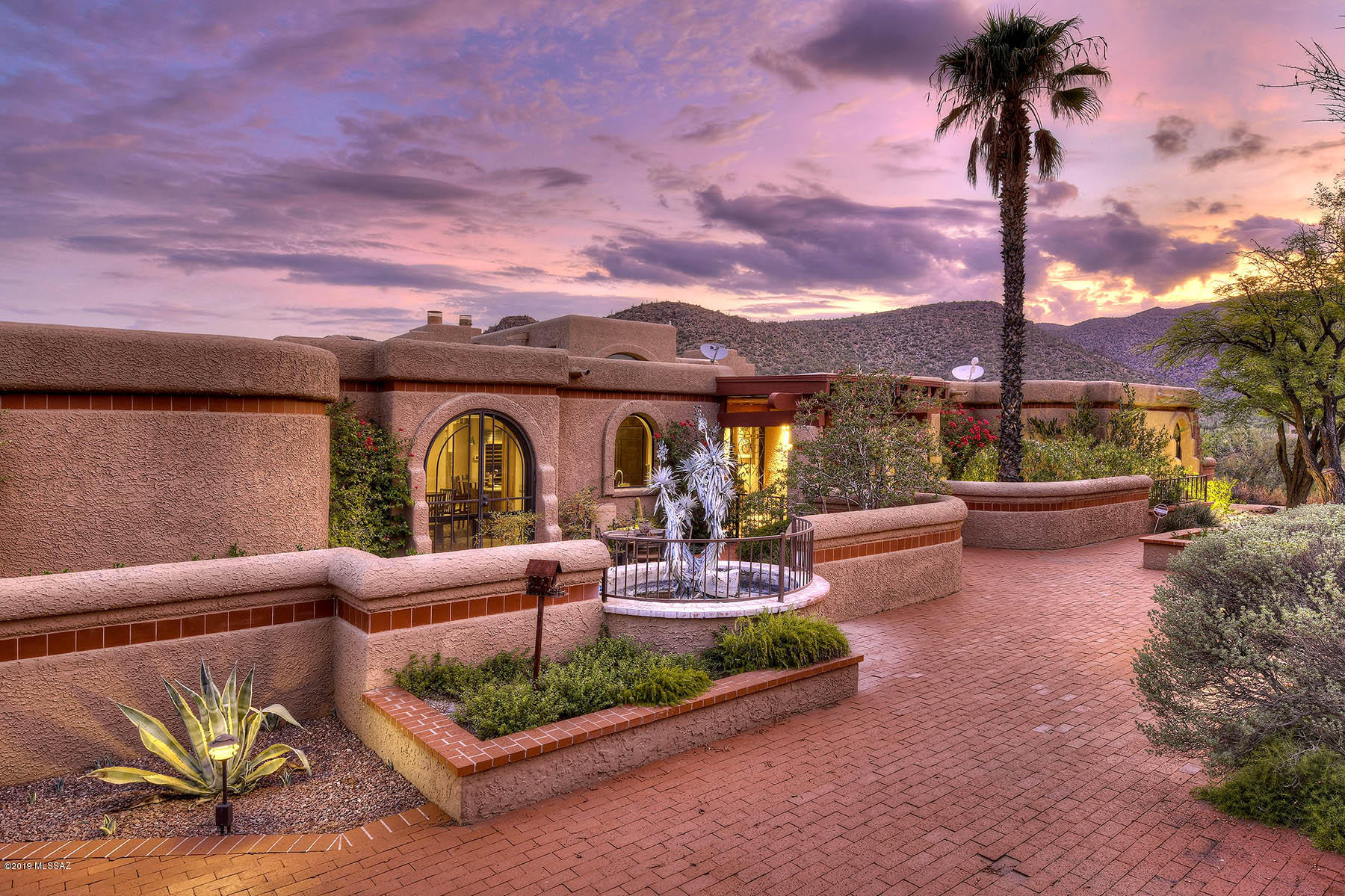 Stunning and updated southwestern contemporary high on a hill in prestigious, gated Redington Ranch, on 3.1 acres with sweeping 360 degree views.  Featuring 4,028 sq. ft. 4 bedroom main house (den could be 4th bedroom), 805 sq. ft. guest house with living and bedroom, enter into great room with soaring ceiling, walls of windows, clerestory windows, fireplace, Egyptian sandstone floors, fireplace, wet bar, formal dining room and Pella windows and doors.  Remodeled chef's kitchen offers granite counters, breakfast bar, breakfast area, Sub-Zero, Miele, stainless steel appliances and gas cooktop.  Glorious master suite has fireplace, views, remodeled bath with glass shower, spa tub, travertine floors and surrounds.  3 car garage, wonderful outdoor areas with brick walkways. Outdoor ramada with BBQ, pool, spa, dog run and did we say . . . views, views, views.  Wonderful community facilities include community horse facility, lake, tennis court, pool and club house.  See to appreciate.