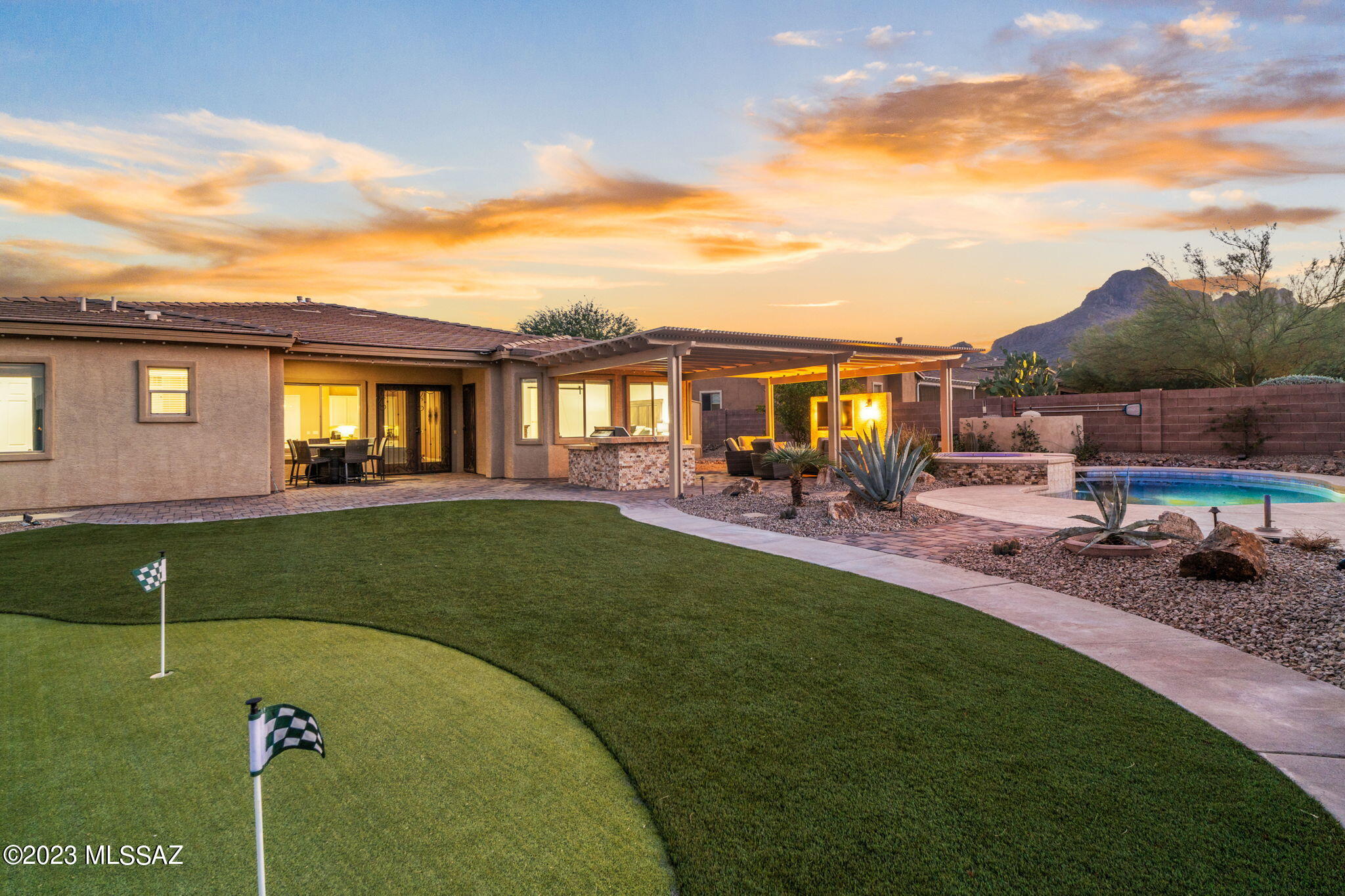 Seller will review/counter offers between 764,900-800K Situated on one of the community's premier lots in gated Ironwood Reserve, strategically positioned, boasting an unparalleled location backing to a natural desert area, with a unique vantage point for unobstructed mountain & sunset views. Enjoy the best of AZ outdoor living in your private desert oasis, w/sparkling pool, spa, $135K in rear yard improvements. Covered outdoor living area w/stacked stone/TV wall, BBQ grill, custom island, putting green, kids playground & custom space for trampoline   This home is not just a residence; it's a lifestyle. Embrace the Arizona desert living with this exquisite property that combines luxurious living spaces & the beauty of the surrounding desert area. Step into luxury as you enter this home, where the spacious living areas are designed with a perfect blend of modern elegance. This 5 bed/3 bath/split plan 3 bath home plus a flex room & 3 car garage. Open concept plan seamlessly connects the family room w/custom built-in bar area & casual dining seating area creating an ideal space for entertaining. Features include, 20x20 tile in all main living areas, custom Iron doors, 4 ½ "wood shutters. 
Gourmet kitchen is located in the center of the home hosting a large center island providing ample space for meal prep, casual dining, and socializing, stainless appliances and high-end gas cooktop, separate pantry. 
Spacious owners' suite was upgraded last year w/ ceramic tile wood plank flooring. & custom barn door leading to new master bath retreat w/sleek quartz dual sink Exec height vanity & luxurious walk-in shower creating a serene ambiance combined with an expansive walk-in closet for functionality. 
One AC replaced in 2022, new pool & spa heater.