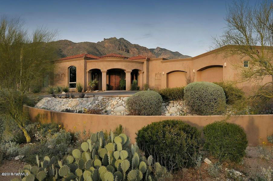 Perched high on hill w/pristine mountain VIEWS! City views at office, guest rms. Exquistitely appointed w/stunning maple hardwood flrs in rich varigated color pattern, plus travertine & marble floors. Cantera columns, granite cntrs, custom made wine rm w/300+bottle capacity. Custom rusted metal patina window surrounds. Remote controlled inen black out shades in MBRM. Full wet bar in Master. 8FT solid Alder doors thruout. Gourmet kit. w/SS Wolf commercial gas range, 6 burners, griddle & 2 ovens, plus Wolf convection oven & oversized MW. SubZero fridge, 2 DW's, ice maker. Fully extended covered patio. Blt in outdoor gas BBQ. Pool/Spa newly designed w/alabaster glass tile & sandstone polished slate reflecting unsurpassed desert vistas.Professionally & sophisticately designed int. & ext.