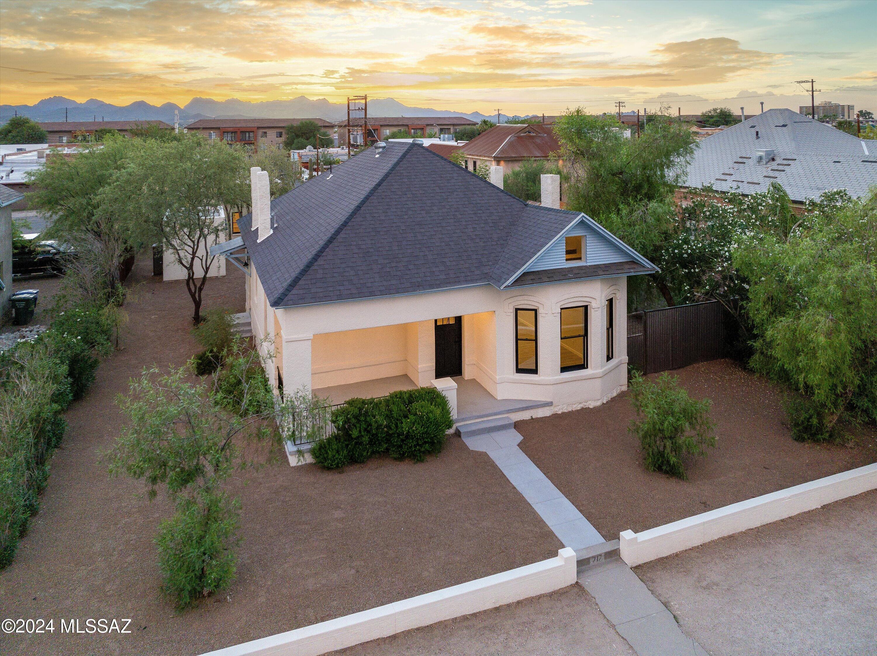 Owner/Agent. 1913 American Queen Anne influenced home with duplex & guest house in Historic West University Neighborhood between downtown Tucson and U of A. New upgrades throughout highlight a modern interior design, in keeping with the characteristics and richness of the early 1900 architectural style with 4 decorative gable rooftop chimneys. All new kitchen features stunning quartzite countertops, soft close cabinetry and dining open to the main living area. The smooth concrete finish accent walls compliment the home perfectly and upstairs attic has been completely transformed offering a creative unique space for guest, game room or office, including a full bathroom & shower. All new tile flooring/trim, lighting, fixtures, fans, doors, windows and lighting throughout all units Additional upgrades in Main SFR-Unit A, Guest House-Unit B, Duplex Unit C & D, include:
New electric system: all on separate panels & separate electric meters, new plumbing to street, new HVACs (all units), new roof-work, including new roof shingles, landscaping, new metal corrugated fencing, fresh int./ext. paint/stucco. Alley access car pad parking.  

Main SFR 1762sqft, Guest House 719sqft, Duplex 997sqft.

Great opportunity to own a newly renovated multi living/family home in a prime location for additional income flow.
 
Just a short walk to Univ Blvd & Historic 4th Ave where you can ride the Sun link streetcar to Maingate Square, U of A, downtown Tucson & Mercado/MSA Annex. Enjoy nearby 4th Avenue shopping eateries and fun, and in close proximity to downtown Pima College and Banner Hospital.

Contributing historic property, Park Wise controlled parking allows to affix a car sticker for front street parking & allows permits for guest(s).
