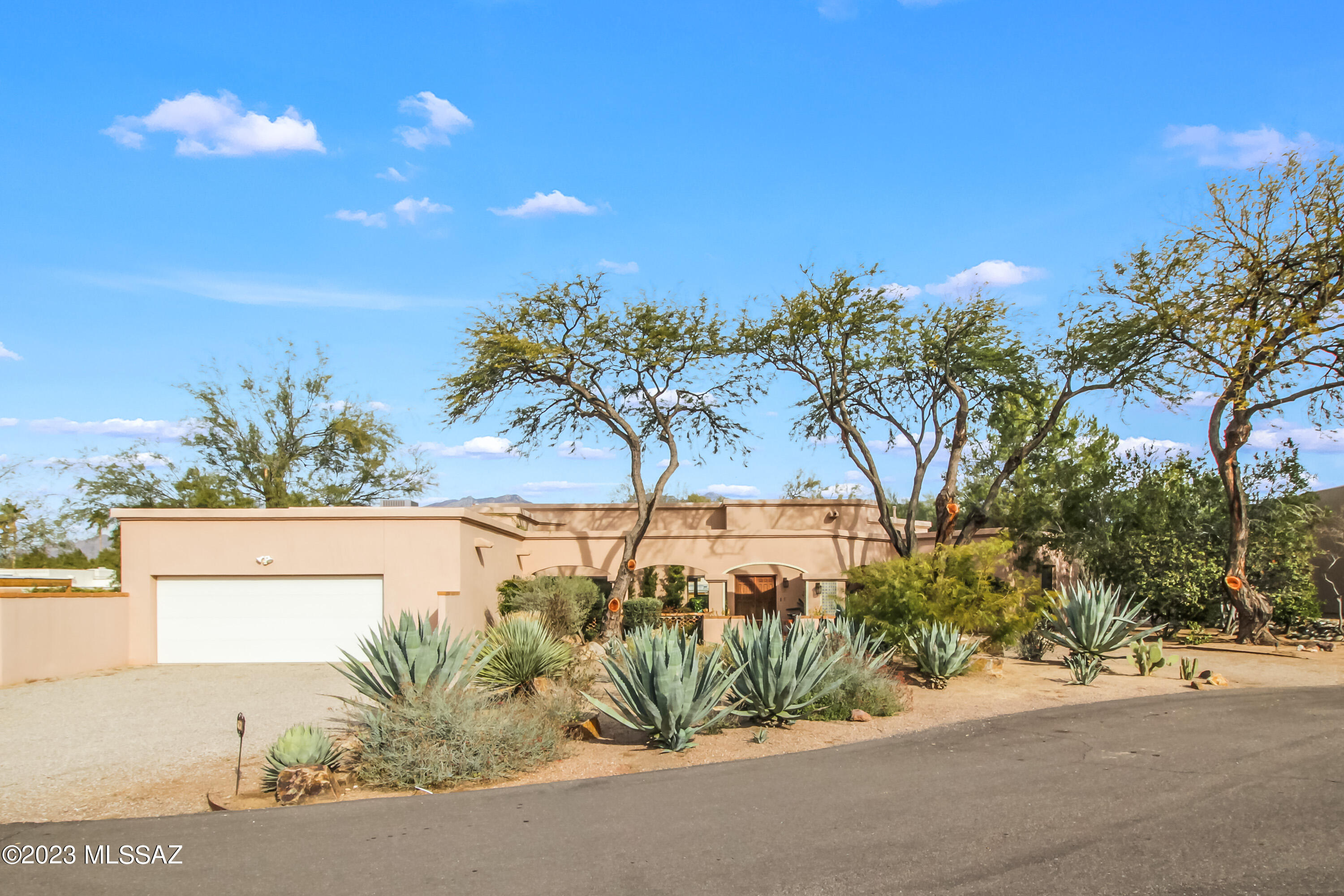 3 Bed 3 Bath PLUS Den/Office! Your opportunity to own in Tucson Country Club Estates and be part of history in the making. As you enter through the gated/guarded gate you instantly feel a sense of home. Mature trees line the streets, and a sense of community is felt passing by the joggers and golfers on their way to Tucson Country Club, a private invitation-only membership which boasts an exclusive 18-hole golf course, tennis courts, pickleball, fitness center, lap pool, splash pad, waterslide and clubhouse with monthly activities for the whole family. (Separate membership is required for TCC, apart from HOA) Split bedroom floorplan, Multiple patios and courtyards. Mountain views. Wood-burning fireplace. Storage opportunities abound in the garage cabinet space and laundry space. [more] Adjacent to nearby Rillito Riverwalk for long-range jogging, cycling and more. Imagine the possibilities of opening the kitchen to greet those gathering in the living area, or maintain the quaint privacy of a chef's kitchen within the existing design. Wine bar and built-in storage house all of your most precious flatware for entertaining. Primary bedroom has step-down office space with a wall of bookshelves and beautiful mountain views. Dual closets provide ample space. Primary bathroom has soaking tub and spa-like shower. Executive height counters boast two sinks and additional vanity space. Solid wood doors throughout, and gallery lighting to show off your favorite photos and art collections. Magical moments live in the nooks of the windows with sills around the corners of the hallways. A private patio off the hallway near the other two bedrooms provides yet another sanctuary to enjoy coffee or tea and watch the birds. Spacious bedrooms have windows with built-in blinds, to elevate the lifestyle of less dusting, more stargazing. Landscaping is lush and inviting, with mature trees for shade and character. Pool-sized yard for possible future development should the desire arise. Lovingly maintained, this home is preparing for its next honorable owner. Buyer to verify all facts + figures, including those in MLS.