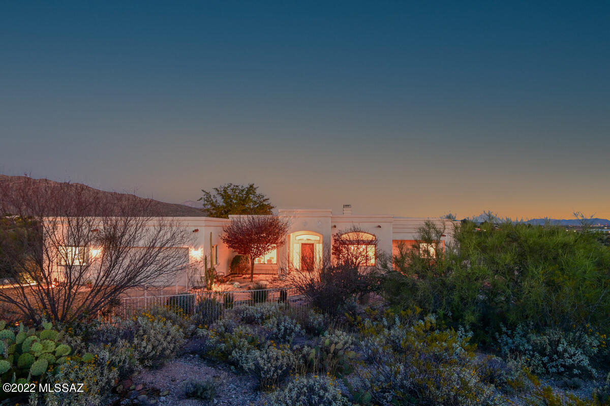 Custom SW Contemporary,located on a spectacular 4.37 acre ridge-top lot. Enjoy expansive 360 degree views.  Lovely gated courtyard & beautifully landscaped yard w/specimen cacti.  The thoughtful design of this home shines through. Each room enjoys outstanding views.  Split bedroom plan ensures privacy. Color infused concrete floors & quartz counter tops add SW elegance.  Formal dining room w/ built in buffet & display niches.  Flex-living/office/den offers many possibilities. Great room: beehive gas log fireplace, high ceilings & views!  Master-suite is grandly proportioned, features jetted tub & sep. walk in shower.  Expansive covered patio is the perfect place to watch the rising of the moon & sunsets hues on the mountains.  Bay 3 in garage is a bonus room: heated & cooled w/sink. Studio work shop or overflow bedroom.  Bonus dog wash tub too!