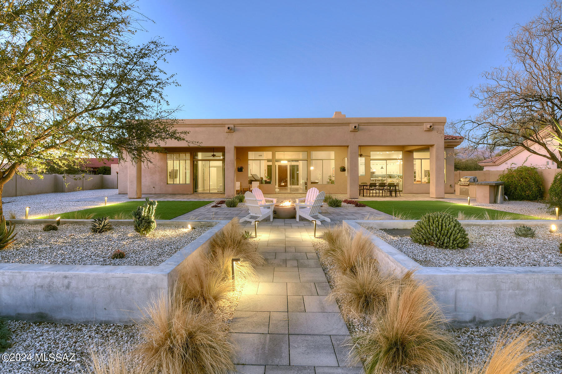 Don't miss this luxurious 5BD/4BA home with 3C garage in the desirable Lakes at Castle Rock gated community. Enjoy the best of Tucson living in this newly renovated home that backs directly up to 73 acres of natural beauty that can never be built on. You'll be greeted by majestic 12-foot ceilings, high-end lighting, wood plank porcelain tile, and spacious living & family rooms with sliding doors to the completely remodeled backyard. Experience true indoor/outdoor living in the meticulously landscaped outdoor oasis w/ firepit, built-in BBQ, artificial grass, and extended patio. The heart of the home is the updated gourmet kitchen & redesigned family room. Entertaining is a breeze with a 6-burner cooktop, dual stoves, quartz countertops, large island, SS appliances, and walk-in pantry. Adjacent to the chef's kitchen is the stylish family room featuring built-in surround sound, floating tile hearth, stunning American Clay centerpiece wall, and gas fireplace. The primary suite is a true retreat, newly updated with a Jason Hydrotherapy tub, sparkling chandelier, spacious dual-head shower & built-in bench, custom cabinets & barnyard doors, and his & hers walk-in closets. The split floor plan provides a large guest wing with 3BD/2BA, ensuring a comfortable and private space for visitors or family members. New HVAC from 2019 and brand-new water heater with recirculation. The large laundry room has an abundance of cabinets and expansive counters that provide generous folding space. The Lakes at Castle Rock includes 14 private, fish-stocked lakes, a fitness center and recreation center - each with heated pool/spa - tennis & pickleball courts, and a basketball court. Steps from excellent walking, jogging, cycling, bird & wildlife watching, and the road to Mt. Lemmon.