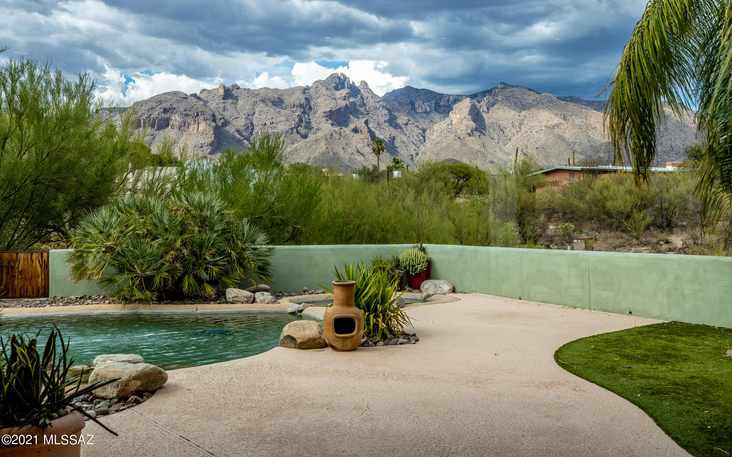 Come see this gorgeous, updated foothills home on 1.35 acres with views of three mountain ranges & city lights. It begins with the circular paver driveway and lush entry courtyard with views of the Santa Rita mtns & city lights. Step inside to a high-ceilinged Great Room with views over the PebbleTech pool/spa to the Catalinas. Enjoy a cook's dream open kitchen with Viking, Asko, granite, and bespoke Alder & Bubinga cabinetry. Owners' Suite offers city & mountain views, privacy, gorgeous custom bath, & big walk-in closet. Find two comfortable guest bedrooms with upgraded hall bath off the kitchen. The ample Den has doors for privacy, and picture windows with views. Don't miss the 3-car garage and extra attached storage shed, perfect for bikes and other toys. Be ready to fall in love!