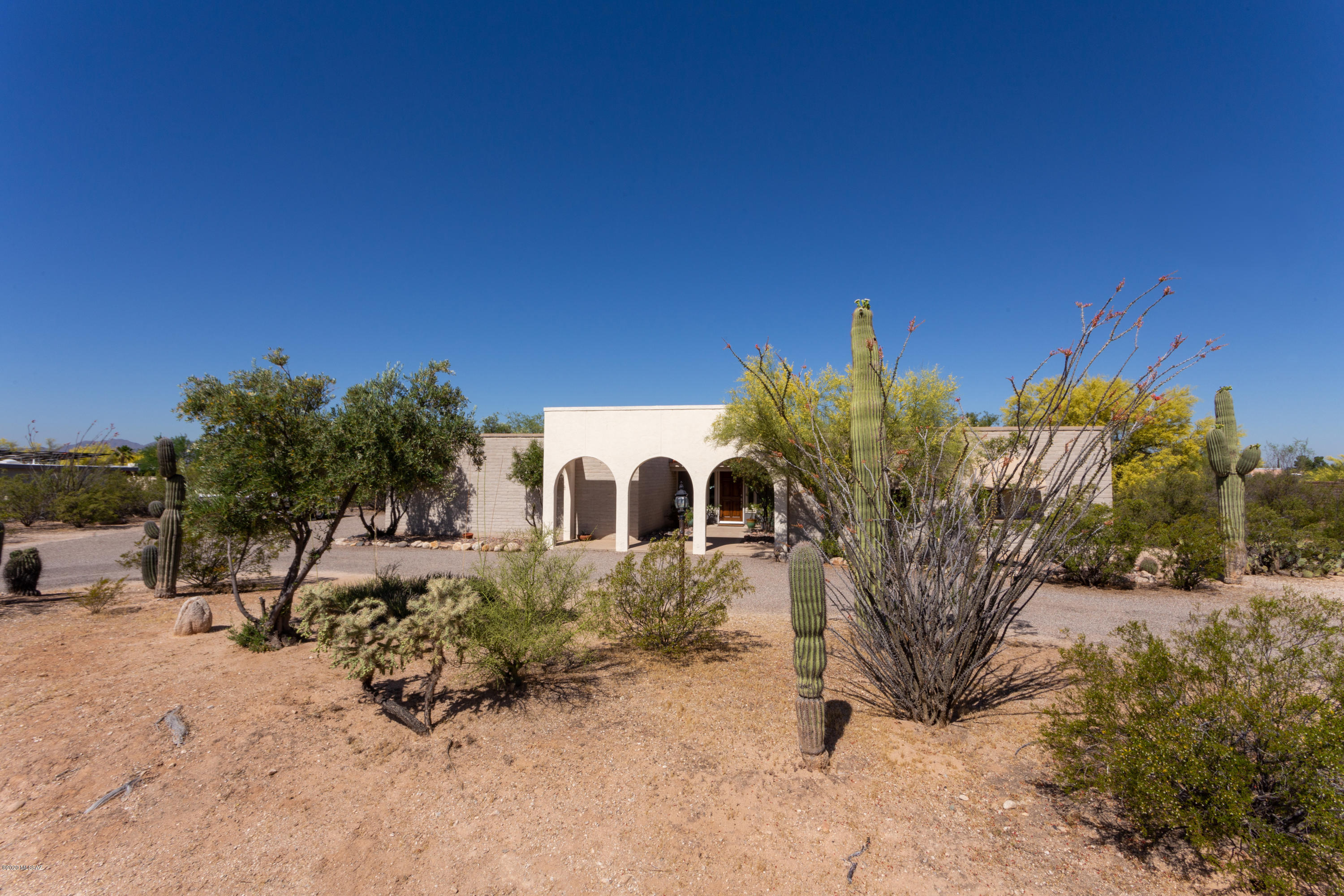 From your first glimpse of this gorgeous half acre property in Casas Adobes, you will notice the love and care that has been put into it. The home has a wrap around driveway with a 2 car garage on the side, as well as double gate access to the backyard. It boasts 4 bedrooms and 2 baths, with carpet and tile throughout the home. With a separate living room and family room with fireplace, there is ample space to create the ambiance you desire. The backyard has a wrap around covered patio, fire pit with pavers, and has no neighbors behind. All that is left is for you to put the finishing touches on it to turn it from a house into your home.