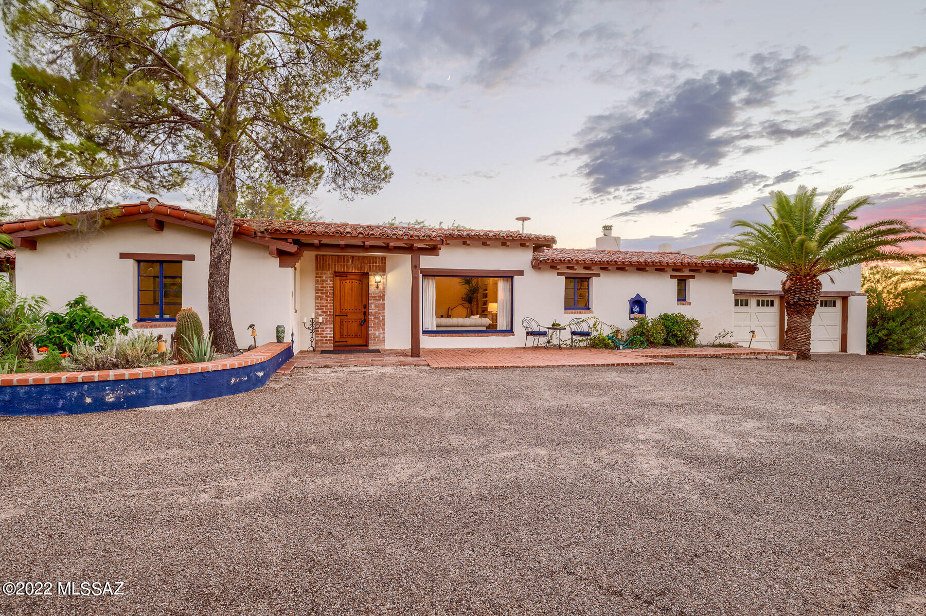 Tucked away in the heart of Catalina Foothills Estates is this original 1938 home designed by famed Tucson architect Josias Joesler.
Situated on a stunning 2.8 acres of lush desert with a sweeping mountain view, this 4 bedroom main house offers original details with gorgeous wood beamed ceilings, adobe walls, concrete floors and distinct Mexican tile in the bathrooms. The generously-sized primary suite features beautiful built-in chest of drawers, wood burning fireplace, wood ceilings and access to the back patio.  The expansive backyard is perfect for entertaining with mature landscaping, large pool, ramada with built in barbeque and wood burning Kiva style fireplace. Head up to the viewing deck above the garage to experience our amazing Tucson sunsets and see 360-degree views. Don't miss the charming Guest house with brick floors and wood ceilings. - 1 bedroom, kitchen, bathroom and basement.