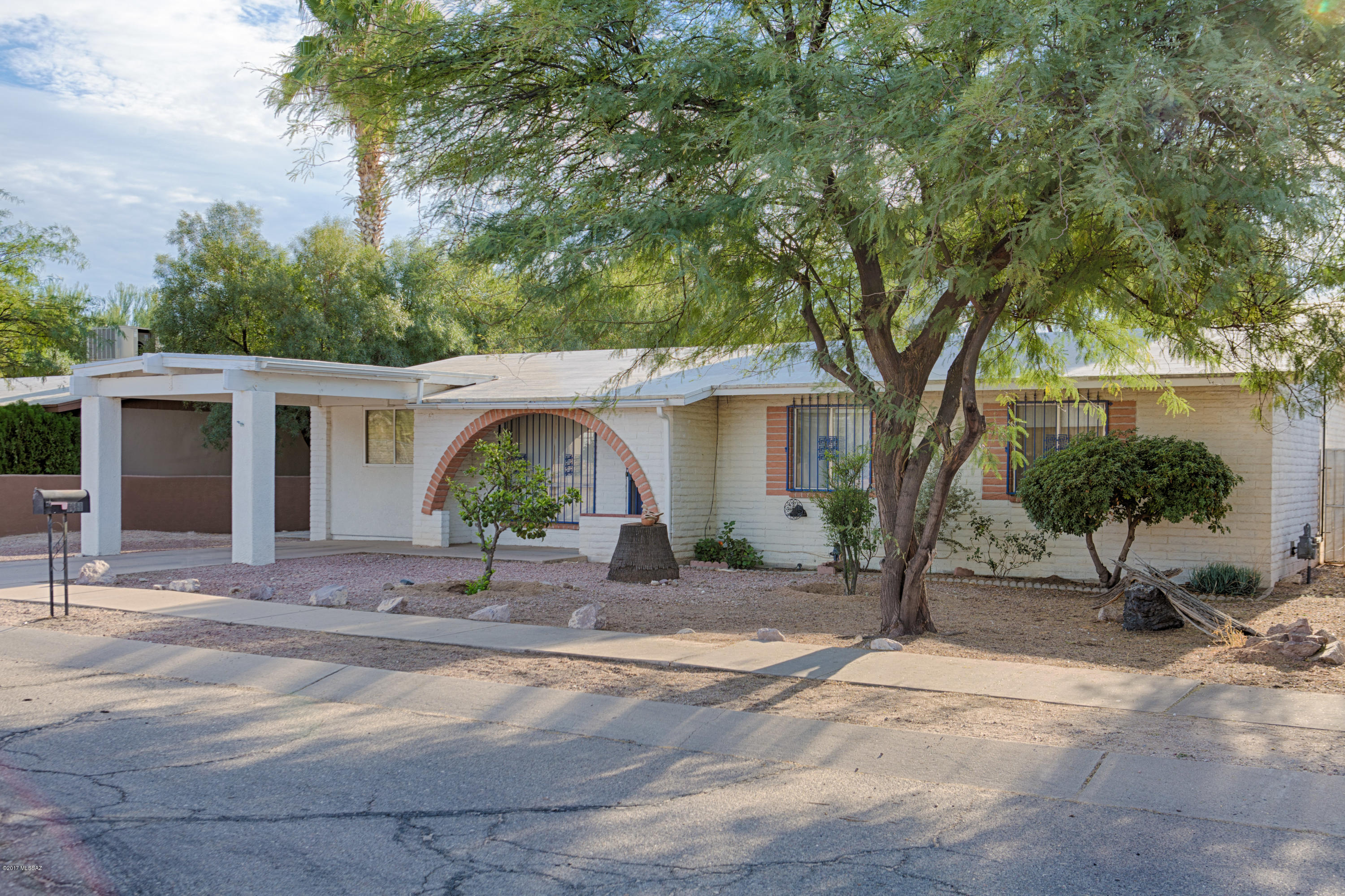 This wonderful 4 bedroom is in a great location just north of River Rd in NW Tucson. So close to many amenities including eateries, shopping, groceries, medical facilities, etc. Home is across the street from the neighborhood playground. You will love this large backyard, let your green thumb go wild. Large 1 car garage in back with alley access. Tile floors throughout with carpet in fourth bedroom. Open kitchen to great room floor plan brings the family together. Enjoy your tiered back patio and large backyard. Plenty of room for a pool, a garden, a sports court, you decide. Come discover all your options!