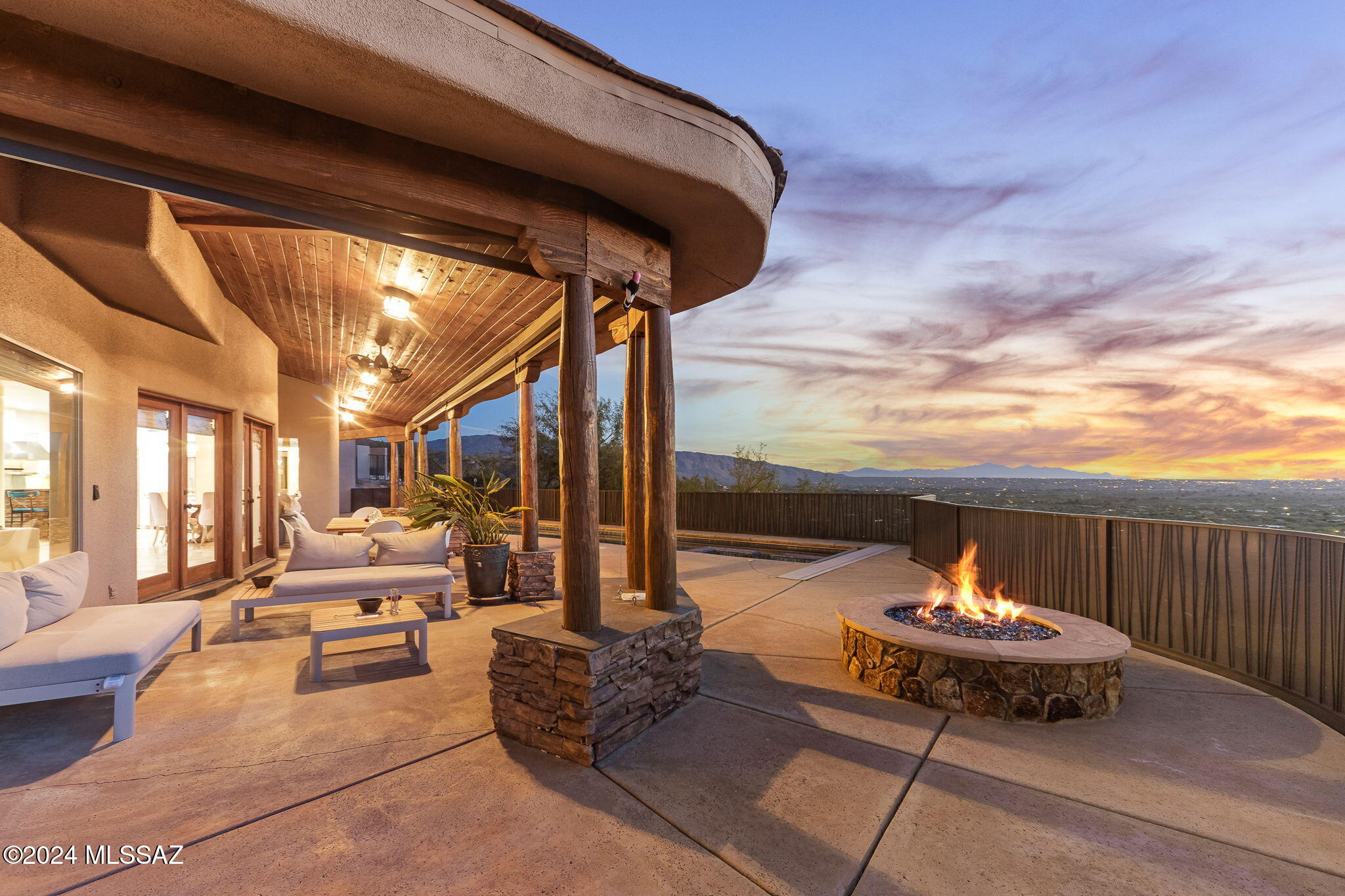 Welcome to a masterpiece of luxury living nestled into breathtaking Catalina Mountain landscape. Remarkable 3+ acre estate combines modern elegance with natural beauty,
offering unparalleled living experience that seamlessly blend the two. As you approach the grand entrance, a stunning custom knotty alder front door invites you in- framed by majestic
granite & flagstone, alongside a multi-tiered fountain & lush landscaping. Step inside to experience soaring 20+ foot cathedral ceilings leading you into a truly grand living space. Great room, with its dramatic stone and wood entry, is bathed in natural light from a wall of windows & French doors, offering panoramic views while
enjoying luxury within. Gourmet kitchen features exquisite agate & mesquite countertops, dual Viking...SEE MORE dishwashers, separate freezer & refrigerator, a Viking 6-burner range with griddle & char grill & a massive walk-in pantry with a dumbwaiter. V- shaped island has a prep sink & storage, coupled with a stainless farmhouse sink boasting a hot & cold on - demand filtered water systems.
Continuing on the tour in this lovely 5-bedroom, 5 full bath home is the primary suite. Situated on the mezzanine level, the room promises ultimate luxury, with hardwood floors, stone-faced walls with fireplace, a walk-in closet & a spacious ensuite bath featuring dual vanities, a steam shower & a soaking tub with 180-degree views. Two sets of doors lead to dual private balconies, making it a tranquil retreat.
Across the catwalk, find another room- this one a loft style bedroom with walk-in closet & full attached bath. Downstairs, another full suite with large ensuite bath and fireplace, can be used as a luxury office or for generational living.
On the top floor are two more spacious bedrooms with a Jack and Jill bath, built in dual desk space & its own den. Additional features include large laundry room off garage with dumbwaiter down to ground floor pantry, oversized 3 car garage, and a floor plan flexible enough for any needs! The lovely separate casita has one large room with kitchen plus full bath & large closet.
Transitioning outdoors, the property boasts a 50-foot lap pool w/ spa & a poolside full bathroom. The backyard includes over 1600 square feet of covered space, perfect for enjoying the jaw-dropping city views. The multi-tiered meditation & sculpture garden, lush with vegetation & fruit trees, offers serene views of the surrounding mountain ranges. Multiple water features encompass the property completing the feel of total privacy. 360-degree views, outdoor kitchen, multiple water features, a gas fire pit with lava rocks, UV- protected flagstone pathways- this property truly has it all. Whether enjoying the city views from the backyard porch or relaxing in the hidden shaded room off the front porch, this home is a sanctuary of luxury & tranquility, perfect for making timeless memories. Tanque Verde schools. Close to recreation, shopping, restaurants & Mt Lemmon.