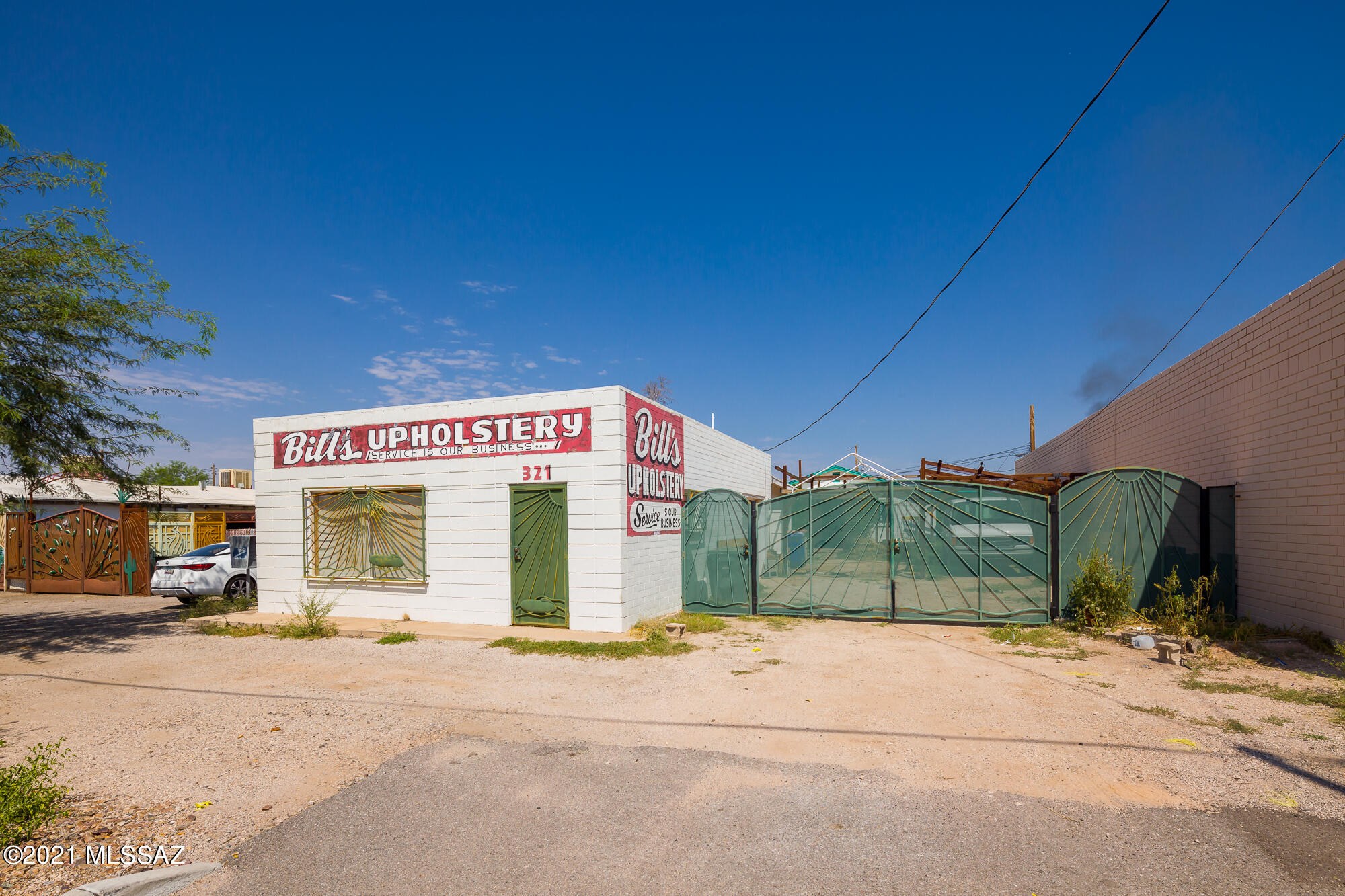 Location, location, location!! Retail/light manufacturing frontage on the newly expanded section of Grant Road. Front building is concrete block with 1,127 square foot storefront/office and a warehouse with a roll up door on the side with easy access off of the driveway. Wrought iron gates open up to allow for additional parking, access to any equipment a business may utilize, or the space could be utilized for storage. Adjacent 1 bedroom/2 bath house is approximately 626 square feet, features evaporative cooling, large front patio and an ample amount of space for an individual. Drywall and subfloors are complete. Entire property is fenced in, quick access to I-10, and offers premium visibility.