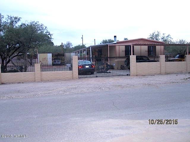Updated inside and out 1981 Redman MFSR. Enjoy the large elevated front porch and then get comfortable in the cozy living area with fireplace. Newish AC.   4 Tandem Carport plus extra storage/shop/garage. Beautiful masonry and wrought iron fence and gates around entire property.  Be sure to note the beautiful custom wrought iron gates and security bars on window.  Separate gated entrance to 2nd mobile w/3 bedrooms (to be conveyed with property) and can be guest quarters or rental income.  Property is a must see to appreciate.