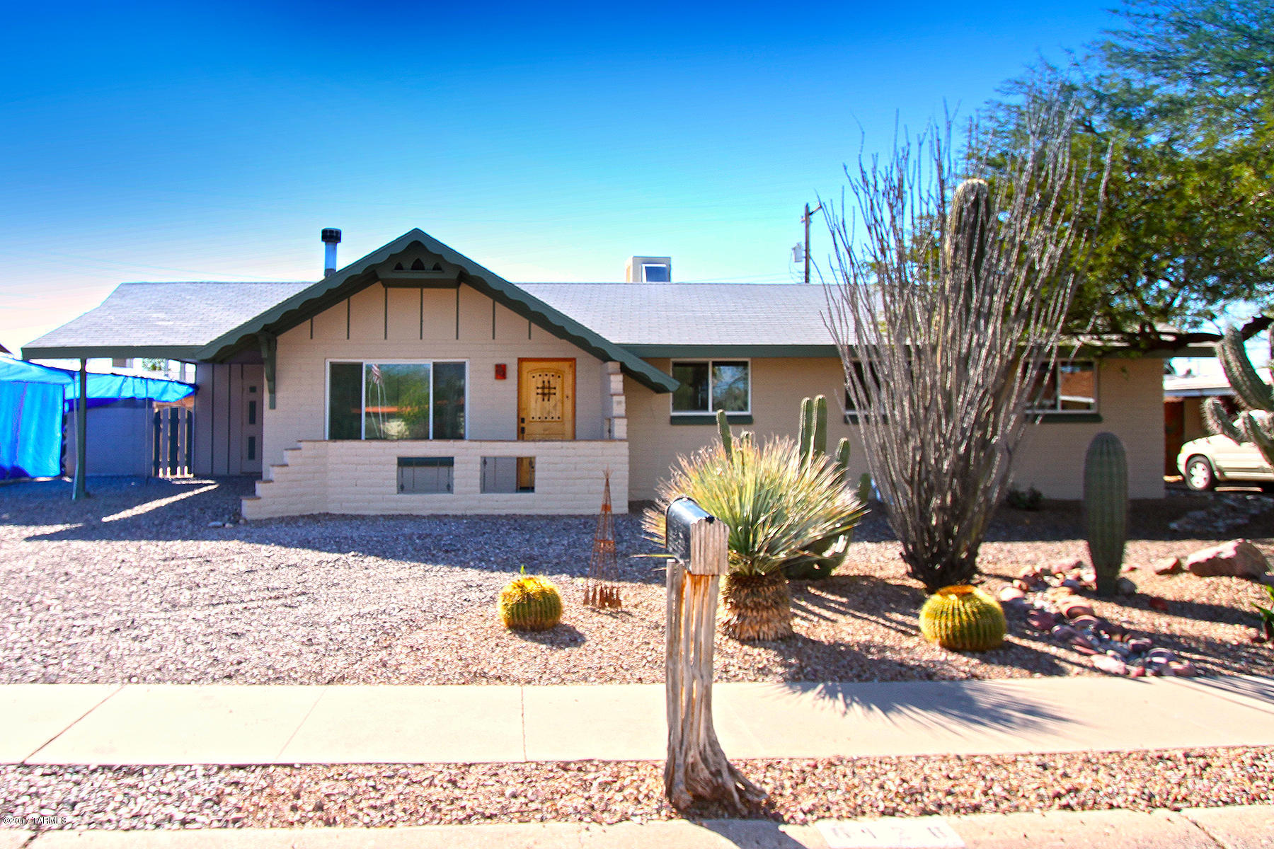 This beautiful home has many unique features and qualities. Enjoy your living area with stone fireplace. Upgraded kitchen including granite counter tops, saguaro ribbed cabinets and gorgeous back splash. Relax in your screened in Arizona Room with running water fall -  Coy pond. Even a partially above ground pool to cool down in the summer heat. This home has a ton of storage and workshop space along with much character and style. You must see it to fully appreciate all it has to offer!