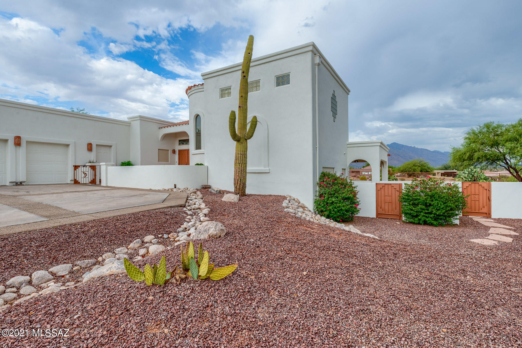 Gorgeous VIEWS of the Omni Tucson National Golf Course and Catalina Mountains. Lovely custom split-level home with east facing backyard patios for afternoon shade and heated pool. Main floor has living room with gas fireplace, sit-up wet bar area, kitchen, dining room with built-in buffet and china cabinet, huge utility room, office, extra office or craft area and half bath. Upstairs is a large master suite, private patio with fabulous views and large bath area with two walk-in closets. Downstairs is a bedroom, full bathroom and a game/rec room with sink.  Oversized two-car garage and cart garage plus large storage room. Home is loaded with storage and flexible spaces.  Game/rec room could be made into third bedroom.  Don't miss your chance to own this one-of-a-kind home in great location.