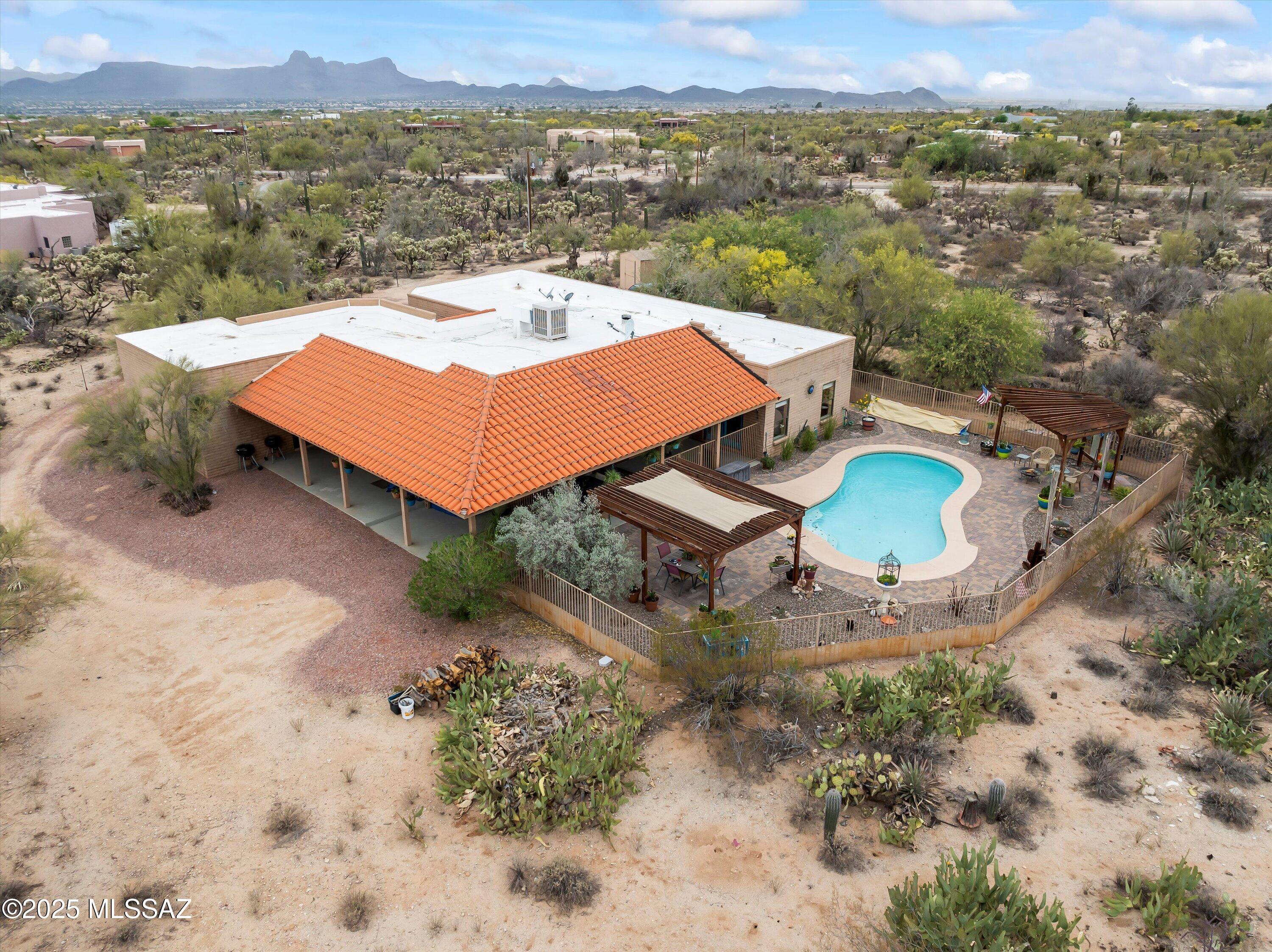 No HOA! Mountain views. Poolside serenity. The Arizona dream awaits. Set on 3.72 acres of peaceful desert beauty, this meticulously maintained slump block home features a split floor plan w/ a private ensuite perfect for guests w/private pool access and Saltillo tile that is  truly gorgeous!  Enjoy the newly replastered pool, wrap around patio, breathtaking Catalina & Tortolita mountain views, and unforgettable sunsets! Outdoor living areas invite entertaining, stargazing, and quiet moments in nature. A hot tub slab w/ hookups is ready for your personal spa experience. Recent upgrades include newer HVAC and water heater for worry-free comfort. Plenty of room for corrals, gardens, RV Parking. Tucked back from the road, you'll feel worlds away yet you're just minutes from ''town! See ''more Just minutes from shopping, dining, and entertainment in Oro Valley and Marana including the Premier Outlet Mall, Dove Mountain, The Ritz Carlton and a plethora of golf courses and dining options. Don't miss this rare chance to live the Arizona lifestyle with freedom, privacy, and unbeatable views.