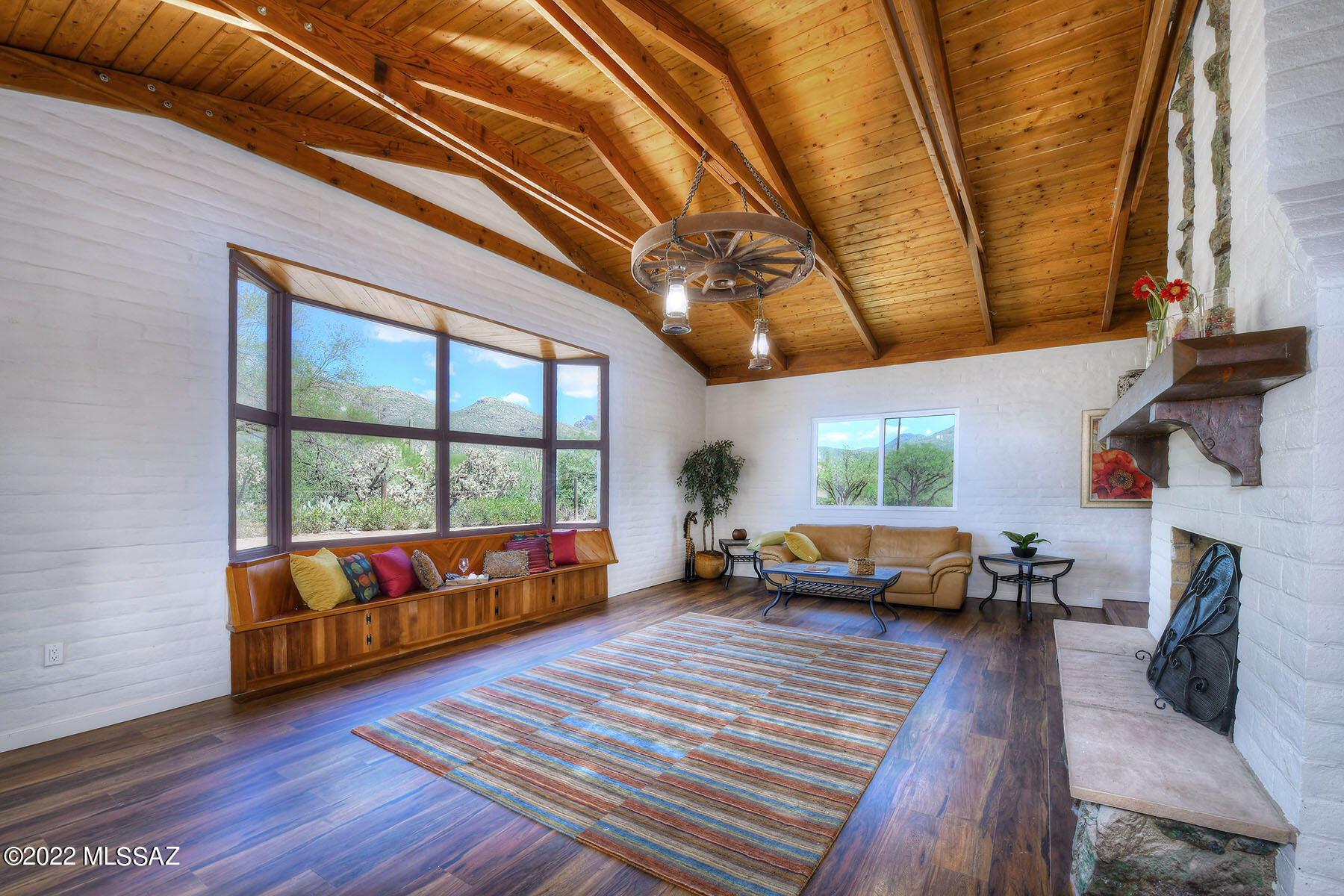 Stunning remodel combining old and new in this Tanque Verde Home. Located on almost 4 acres near the base of the Catalina Mountains, it offers a very special retreat.  Step into the living room featuring a ceiling with raised hand-built trusses, custom decking, stone fireplace & wonderful mountain views. An open kitchen with large walk-in pantry, includes an eating area, and a separate dining area.  The bedroom wing includes 4 bedrooms, 4 baths, laundry and an extra room for workout or storage.  An additional bedroom is off the Arizona room with a separate entrance and mini split.  A guest house is also located on the property and offers potential to make it your own. A second parcel adjacent to property is included in the sale. New HVAC.