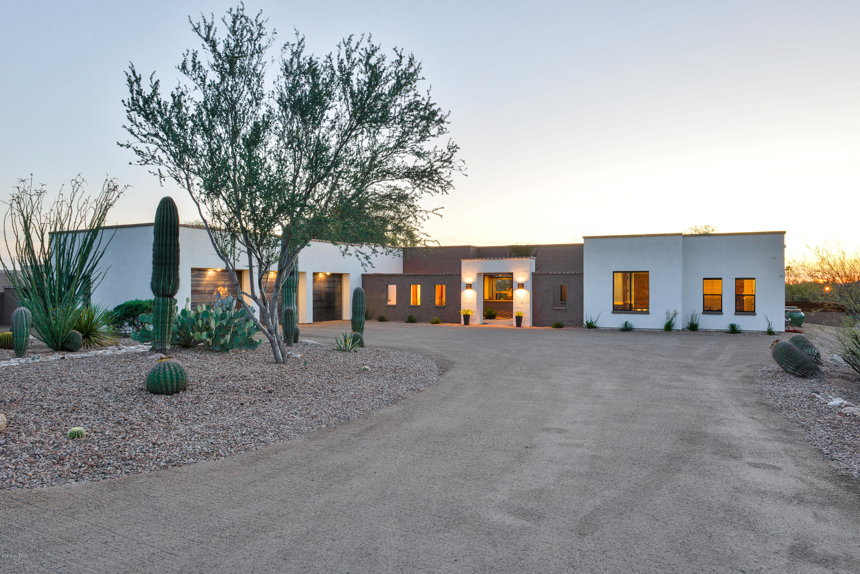 Spectacular 2016 remodeled home by Ron Ronbinette, sits on private .8 acre lot in the heart of the Shadow Hills and is within the highly desirable Catalina Foothills District 16 School District. This 4245 Sq. Ft. home exudes character featuring a split plan with 4 Bedrooms, 4 1/2 bath, 8' Alder doors, Travertine floors, great room with beamed ceiling. The gourmet kitchen has everything you will need including Wolf range, two dishwashers, prep sink and 48'' refrigerator. Resort style backyard with pool, basketball court, playground with large masonry walled backyard. Master en-suite feature double custom vanities, huge walk-in closet with washer and dryer, soaking tub, oversized walk-in shower & private patio to backyard. All three guest rooms are en-suites.