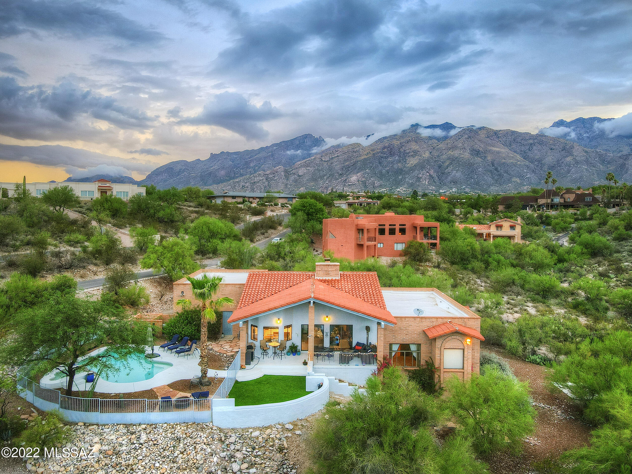 Ideally perched on a hillside lot, this spectacular home offers incredible views of the mountains, city lights and sunsets that you can enjoy from the covered patios, pool or spa. The vaulted ceilings and large windows create a sense of openness and serenity. Instantly enjoy your new home knowing thoughtful renovations were recently completed. The updated kitchen includes quartz counters, a tile backsplash, stainless appliances, custom cabinets and a breakfast bar that opens to the living room. High-end touches continue in the living room, with a wine bar, wood-look flooring, cozy fireplace and access to a covered patio and sunrise/sunset views. The owner's retreat features a luxurious ensuite bath, complete with dual sinks, a spacious walk-in shower, and stress-relieving soaking tub. With 4 bedrooms and 2.5 baths, there is plenty of space for everyone, and options for a home office or fitness room. Life can be hectic; you deserve a retreat to call home.
