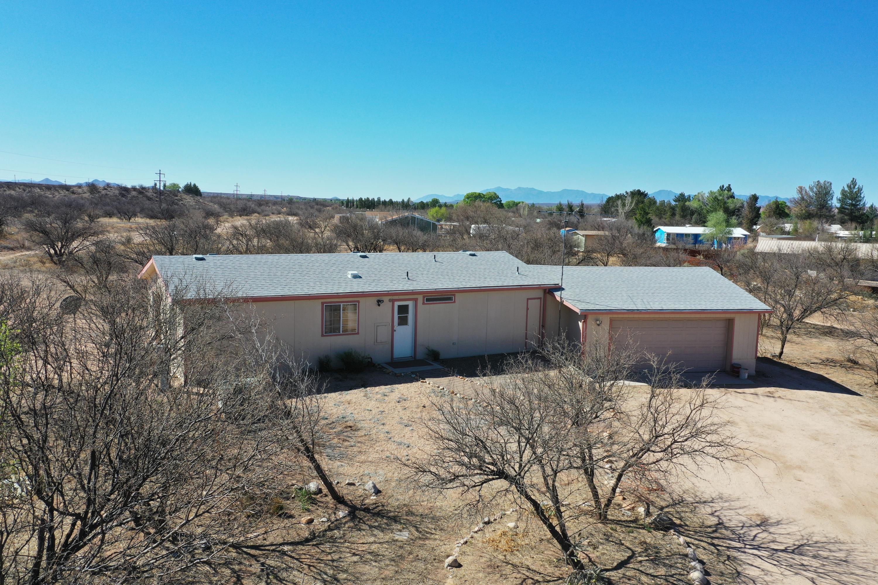 2 bedroom, 2 bathroom on 1.29 acres. Mature mesquite trees. Large 22x28 garage. A/C and upgraded dual pane windows. With a little TLC this home could be beautiful.