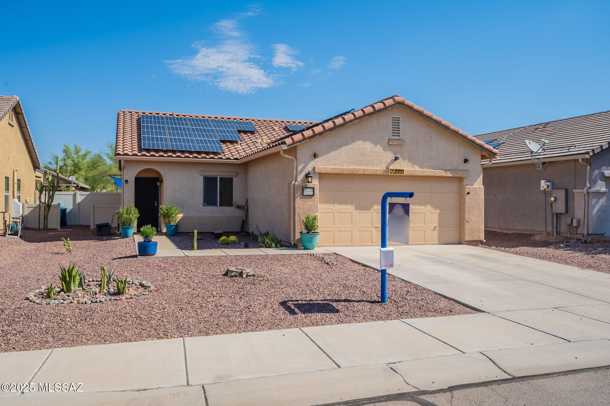 Charming Move-In Ready Home in Red Rock Village
Built in 2007, this inviting 1,252 sq ft single-story home features 3 bedrooms and 2 bathrooms, and has been meticulously maintained by its owner. The open floor plan showcases tile throughout shared living areas and a cozy eat-in kitchen that flows into the living room--perfect for entertaining. A sliding glass door opens to a peaceful back porch surrounded by mature trees.

The home offers a two-car attached garage , built-in speakers, ceiling fans, double-pane windows, and a functional laundry room. Nestled in a vibrant community, you'll enjoy access to pools, a convenience store, skate park, playgrounds, bike and walking paths, and a K-8 school just steps away. Plus, highly rated Santa Cruz Valley Union High School.