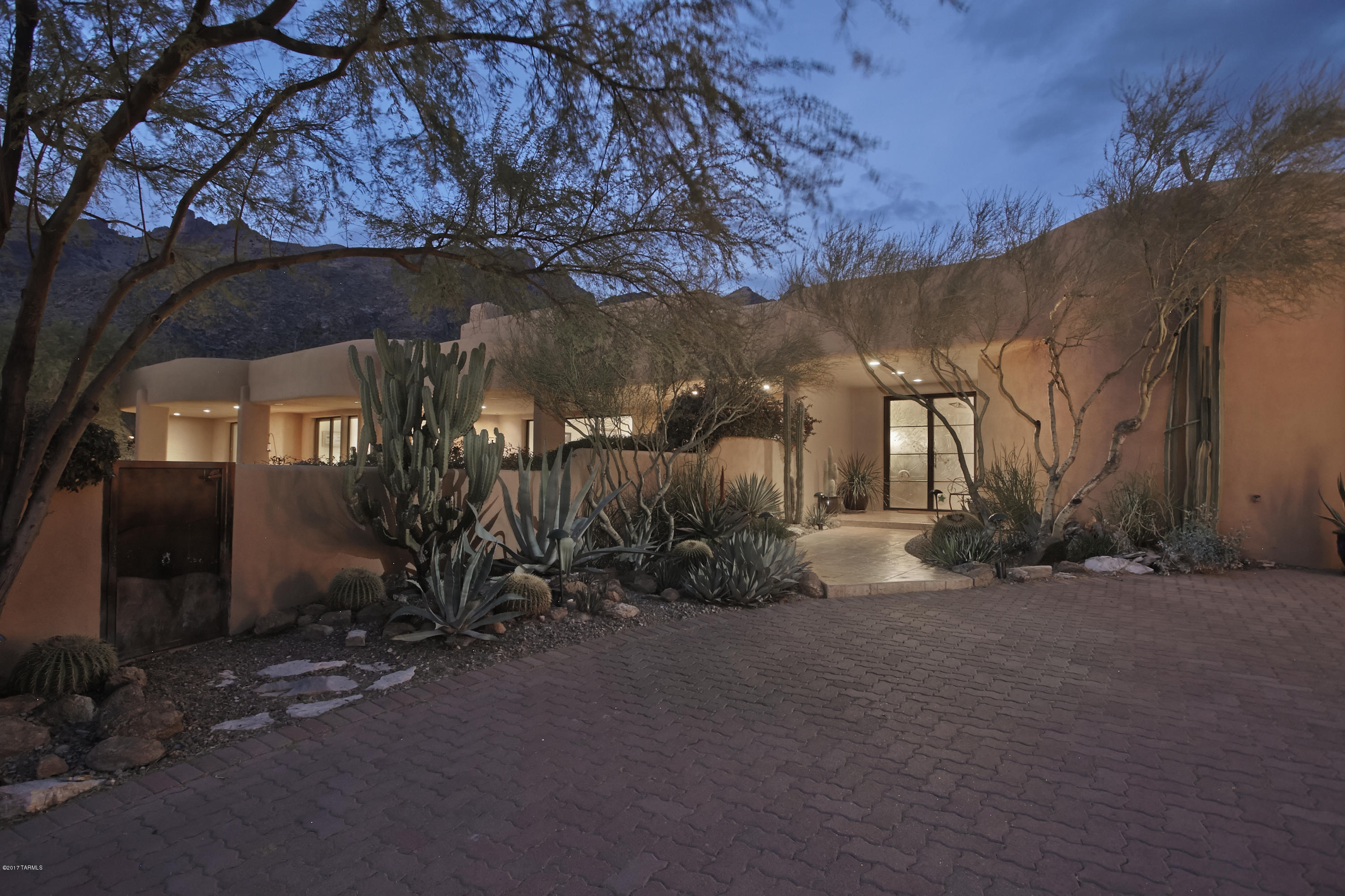 A stunning home situated on one of the finest lots in Tucson's Premier gated community, The Canyons. Bordering the Coronado National Forest, the home affords views of the mountains & into the canyons as well as awesome city views. The extended porch with fireplace, patio & infinity pool provides an unsurpassed venue for outdoor entertaining above the twinkling city lights and dramatic sunsets. The grand & spacious rooms w/walls of windows framing the mountain views provide an equally outstanding space for entertaining and showcasing an art collection. The gourmet kitchen w/island opens onto a family room w/fireplace. The master wing features a spacious bedroom w/city views, his & her bathrooms, private study & studio. The guest wing offers 3 bedroom suites, exercise rm & large wine cella