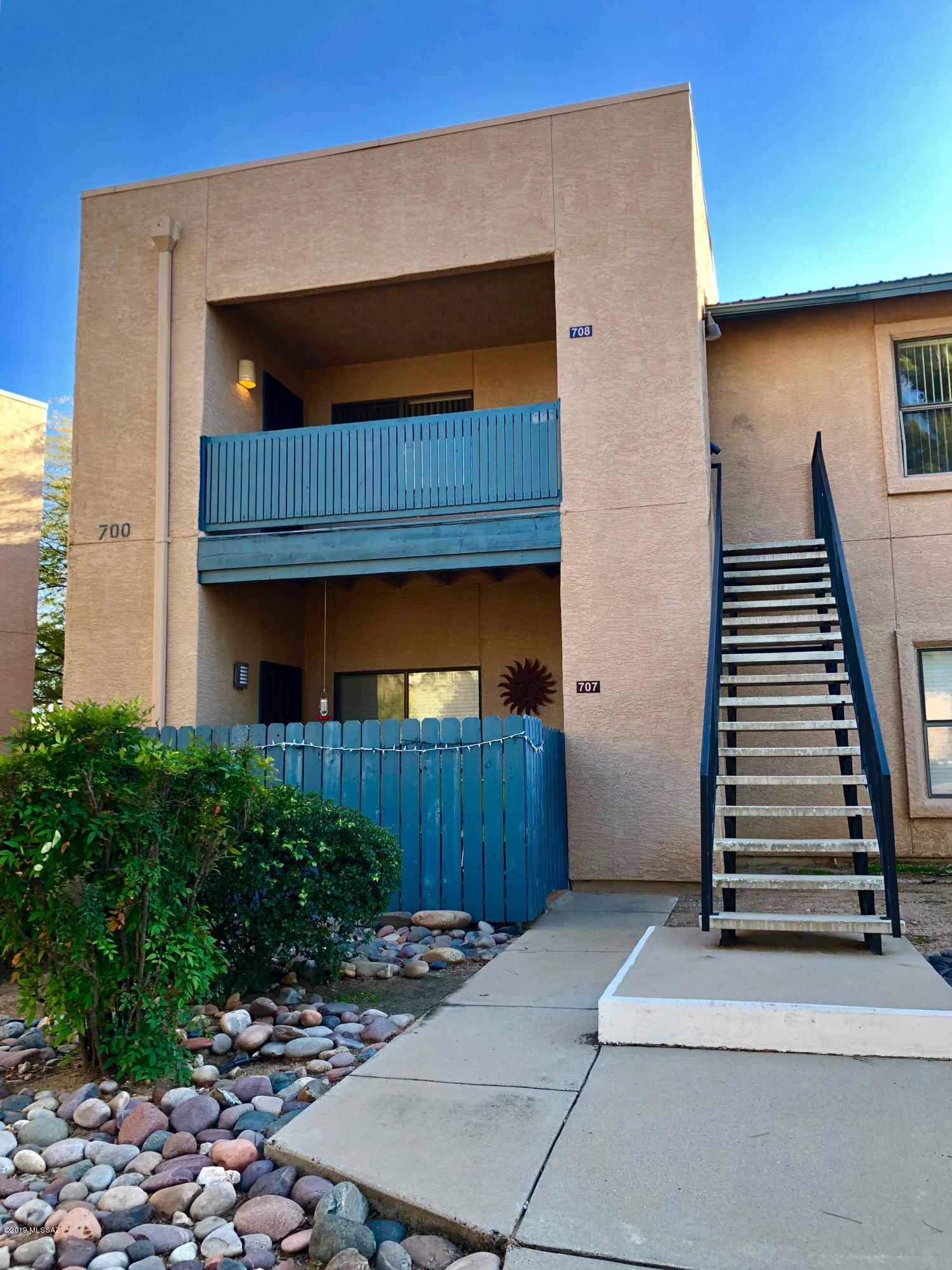 Welcome home to this bright & spacious second story end unit in the lush & well maintained community of Rincon Village. This 1032 square foot condo has 2 large bedrooms with 2 full baths. Modern & contemporary wood laminated extends throughout the condo & there is plenty of storage space with large closets & a built in buffet with cabinet space in the dining room. The balcony boasts a large storage closet with a security gate plus a wonderful view of the mountains. This is an excellent east side location-only minutes from shopping, entertainment, & university or downtown. HOA fee covers water, roof, building exterior maintenance, pool & spa. Visit & Fall In Love!