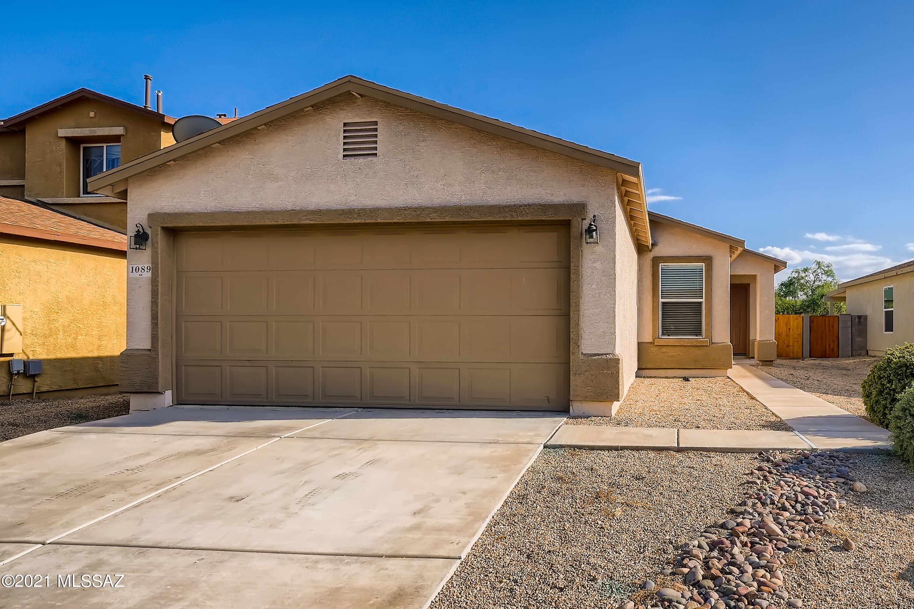 Prepare to be impressed with this superbly maintained, 3 bedroom and 2 bathroom home located in the Santo Tomas Village in Sahuarita! This is a home with incredible curb appeal that welcomes you right in. You are greeted by the spacious feel thanks to the open concept living space as you enter the house. You will fall in love with the well-acquainted kitchen, complete with a breakfast bar, ample counter space, and a pantry. Enjoy the backyard with a covered patio and views of the mountains. The home also features generously sized bedrooms, and the light-filled primary bedroom boasts a stylish en suite bathroom and a walk-in closet. Great location near the freeway, shopping, restaurants, schools, and parks. Do not miss the opportunity to see this remarkable home!