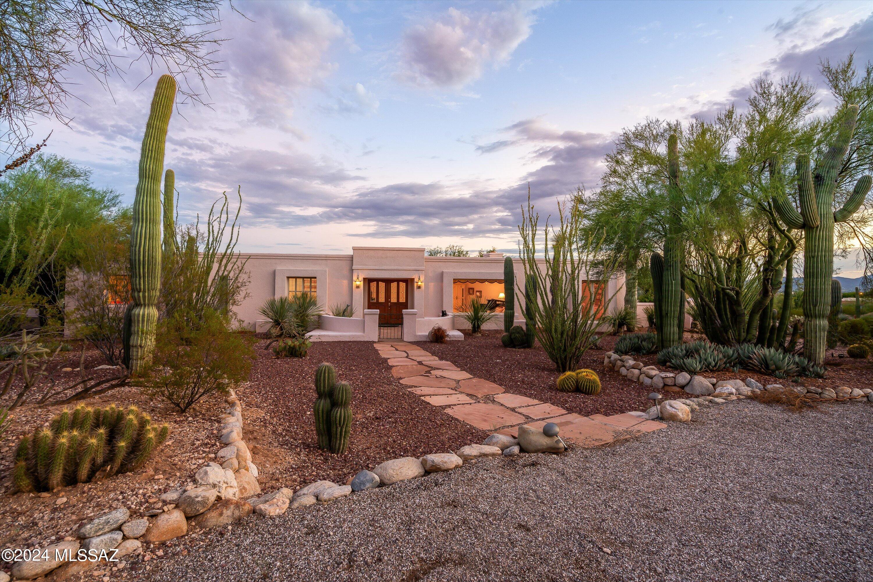Stunning City and Mountain Views! Nestled in the quintessential Catalina Foothills Estates 7, this exceptional property is a rare find. The original owners are ready to pass on this well-loved home to a new generation. With solid masonry construction and 2,933 square feet of living space, there's plenty of room to spread out. The formal living and dining rooms are bathed in natural light, creating an inviting atmosphere. The bright and airy kitchen, complete with a breakfast nook, opens to a charming flagstone patio. The cozy family room features a fireplace, wet bar, built-in shelves, and exposed wood beams, leading out to an expansive covered patio. The outdoor spaces are truly beyond words. Terraced steps lead down to a pool area, offering unobstructed mountain views that make every