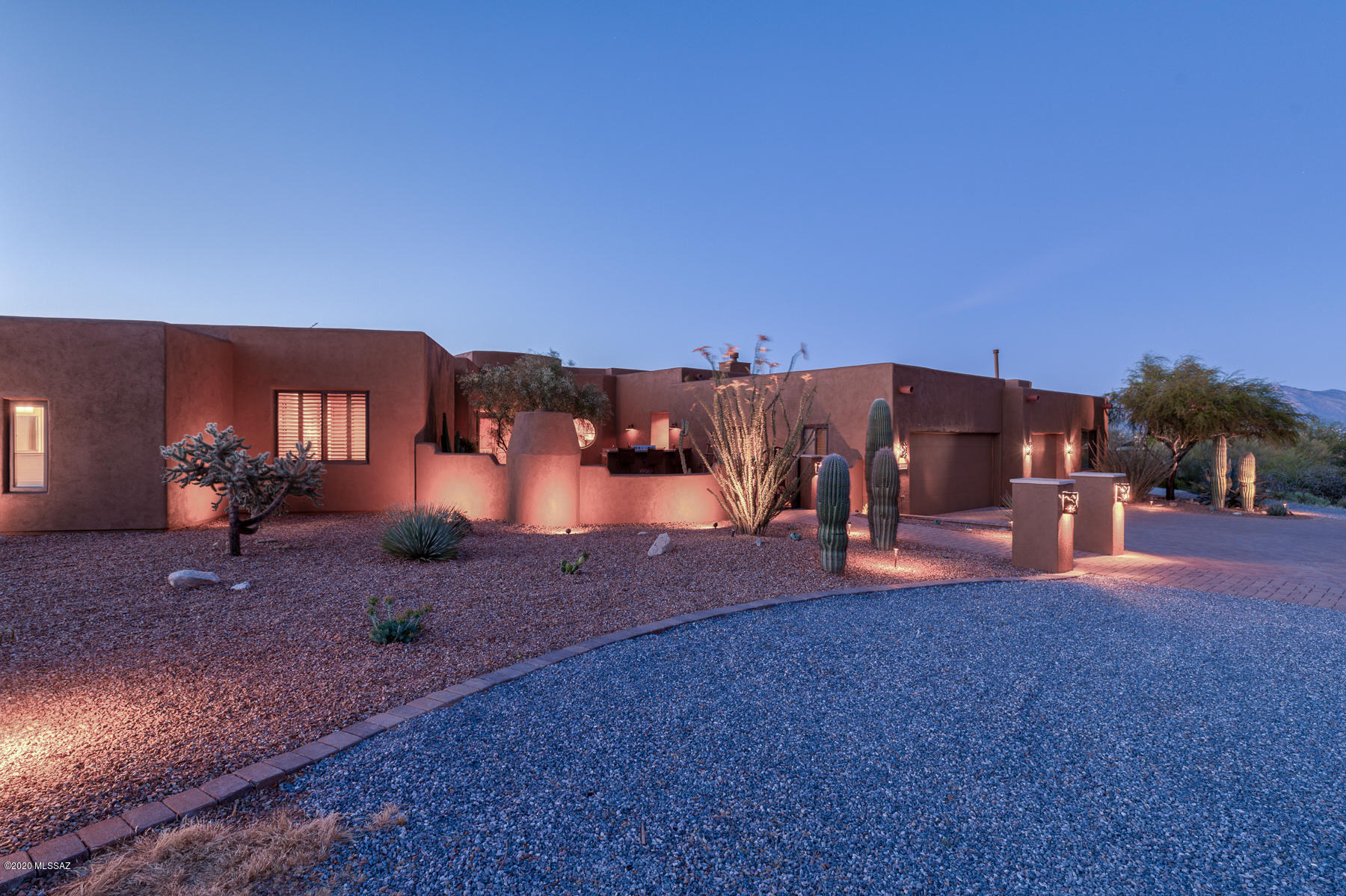 This 3816 sqft custom home was built on 3.55 acres in Tucson Mtn foothills, featuring 4 bd, 4 ba, 3 car finished garage, RV slab and courtyard w/fireplace, fountain, and outdoor kitchen w/built-in BBQ. The Great Rm has 13 ft ceilings and large picture windows, 10x10 ft foyer, fireplace, TV, 11 ft Wet Bar, and doors to180 degree covered patio. The gourmet kitchen off Dining Rm includes refrigerator/freezer, Wolf appliances, warming drawer, 2 granite islands, prep sink, and farm sink with a round 4 ft picture window. West wing has 3 bedrooms, 2 baths + Powder Rm, Laundry/Craft Rm, and Home Theater w/screen/projector. East wing has Master Bed Rm w/fireplace, TV, and patio door. Master Bath has 2 granite vanities, Jacuzzi tub, walk-in shower and walk-in closet. Home system audio is throughout. Step into this beautiful custom home built by award winning Bauer Homes, that is meticulously crafted for the most discerning clients. This luxury 3816 sqft, 4 bd, 4 ba home sits on over 3.55 acres nestled in the Tucson Mountain foothills 2 miles from Saguaro National Park with mature Saguaro cactus, adjacent wildlife corridor, and mountain/desert/city views for miles. The unique interior features of this home include travertine flooring, granite counter tops, 13 ft ceilings, 8 ft high doors, wood window shutters, and large Pella picture windows with 8 ft headers. Further features include a sound proof home theater room, media sound system throughout the home, ready HD TV connections all rooms including 6 wall-mounted HD TVs, unique accent lighting and ceiling fans throughout the home.

Other features include a finished 3 car garage with lighted work bench area and walk-in storage, an off-garage spacious Hobby Room, an entertainment sized courtyard, and a 180 degree surround back covered patio with 9 retractable shades and 3 stairways. Home further includes custom niches and custom cabinets throughout, central vacuum, water softener, security system and a 35 ft RV slab with full 50A hookups.

You will be delighted the second you pull up to this desert sanctuary from a large circular drive and greeted by the spacious fenced courtyard with wood fireplace (gas starter), 4 tier fountain, and outdoor kitchen with built-in BBQ with surround bar. Ample dining and seating areas are throughout courtyard.

Your front entrance is from a large covered area through 8 ft wide double doors with sidelights, welcoming you into a 10x10 ft Great Room foyer with 5 side niches and chandelier with soffit tray lighting above a 5x5 ft marble rug. The Great Room features 13 ft ceilings, gas fireplace with large HD TV above solid Redwood mantel, and large picture windows with unique 180 degree views, showcasing Wasson Peak with stands of mature Saguaro cactus as far as the eye can see. An 11 ft wet bar off the Great Room includes a TV, sink, ice maker, beverage server, custom storage cabinets, and glass door custom cabinets. Two window doors, including an 8 ft wide folding door, provide ample access to the back patio. A Dining Room off Great Room also has 13 ft ceilings with large picture windows with 180 degree views, and double window doors for patio access.

You will fall in love with the gourmet kitchen with walk-in pantry and custom shelves with backlit artistic window door, breakfast nook with large viewing windows and window door to patio, built in Sub-Zero refrigerator/freezer, Wolf appliances including warming drawer, 2 stainless steel custom open drawers, 2 granite islands, prep sink, custom cabinets, and a 4 ft round picture window above a farm sink.

West wing boasts 3 bedrooms, 2 baths + Powder Room, huge laundry/craft room with outside window door access and Home Theater w/ screen and projector and 7.2 surround sound, accent lighting and custom cabinets. The Laundry Room features a sink, coffee maker with counter, beverage server, custom cabinets, and large storage closet with custom shelves.

The East wing will be your private Master Retreat, having a Master Bedroom with a cozy gas fireplace with HD TV above a solid Redwood mantel, large picture window for mountain/desert/city views, a double window door to patio, and unique accent lighting. The adjacent spacious Master Bathroom features double granite vanities with her counter drawer and seating area, Jacuzzi corner tub with chandelier, stone surround and between-the-glass shaded corner windows, walk in double headed shower with granite bench, stone surround and grab bars, unique accent lighting, custom cabinets and walk-in closet with custom cabinets.

This is a rare opportunity for you to own this stunning one-of-a-kind estate!