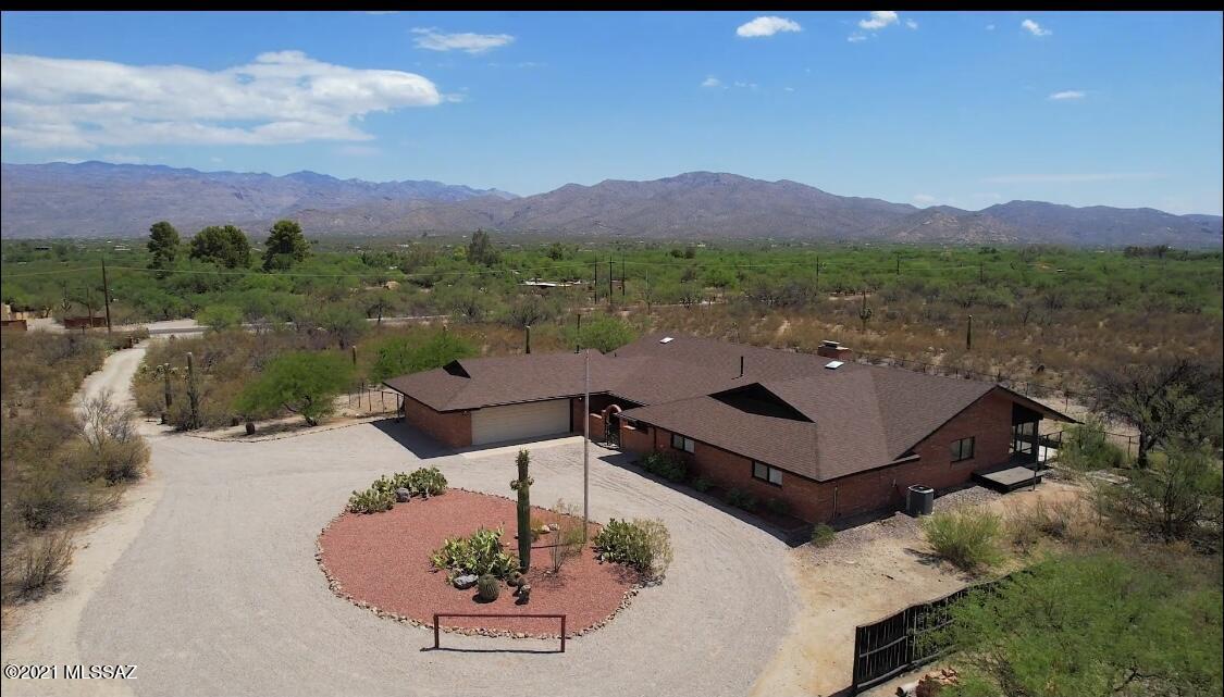 Range Listing 895K-925K. This fully remodeled Ranch Oasis of your dreams, completes with horse facilities that border Saguaro National Park East! Grand open floorplan has 3345 sqft with spacious bedrooms, mountain views throughout the property, updated kitchen w/ new gas stove, double ovens, and large island looking into the mountains. Sunken living room with vaulted ceiling, fireplace and library. Owner's suite has a huge walk-in closet, a spa like bathroom, and continues concrete flooring through the Arizona room and outside patio. Amazing 5-stall custom block barn w/oversized 14x20 foaling stall, feed room, tack room w/hot & cold water, palpation/treatment chute, paddocks, and round pen. Access to reclaimed water for irrigation/pastures possible if 10 acres purchased. New roof!