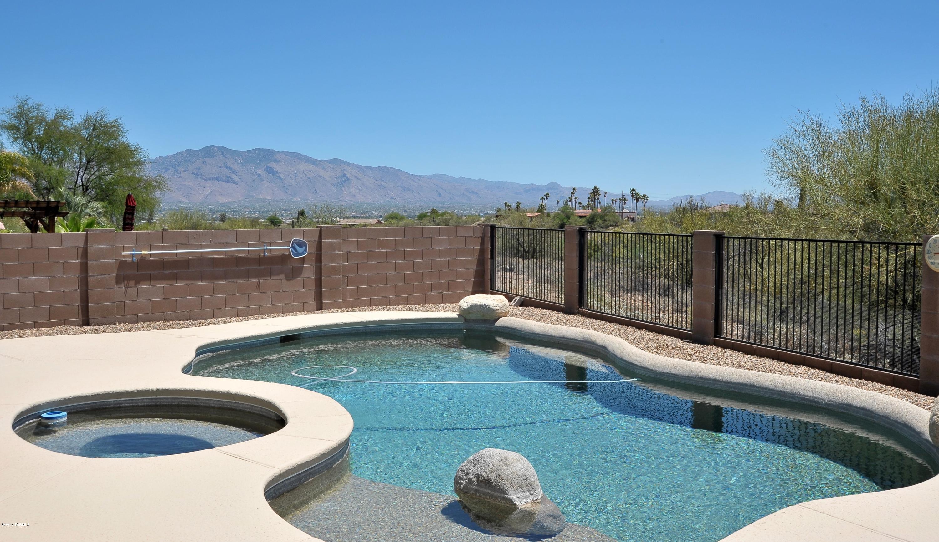 Located in a quiet gated community - upgraded inside & out. Private backyard retreat (no neighbors behind), covered flagstone patio w/fans, pebbletec pool w/Kool Deck, mountain views. Home’s meticulously maintained interior is newly painted. Kitchen upgraded w/custom hickory cabinetry & granite counter tops, Kenmore Elite gas stove, GE convection/microwave, GE Profile refrigerator, LG washer & dryer, Bosch dishwasher. MBR includes custom hardwood walk in closet system. Queen wall bed in 1 bedroom w/built-in cabinets suitable for home office. 3rd BR has wall of hardwood cabinets. Oversize 2.5 car garage w/cabinet storage & workshop space. The exterior painted w/energy saving ceramic. The property is quietly understated and the yard requires almost no maintenance.