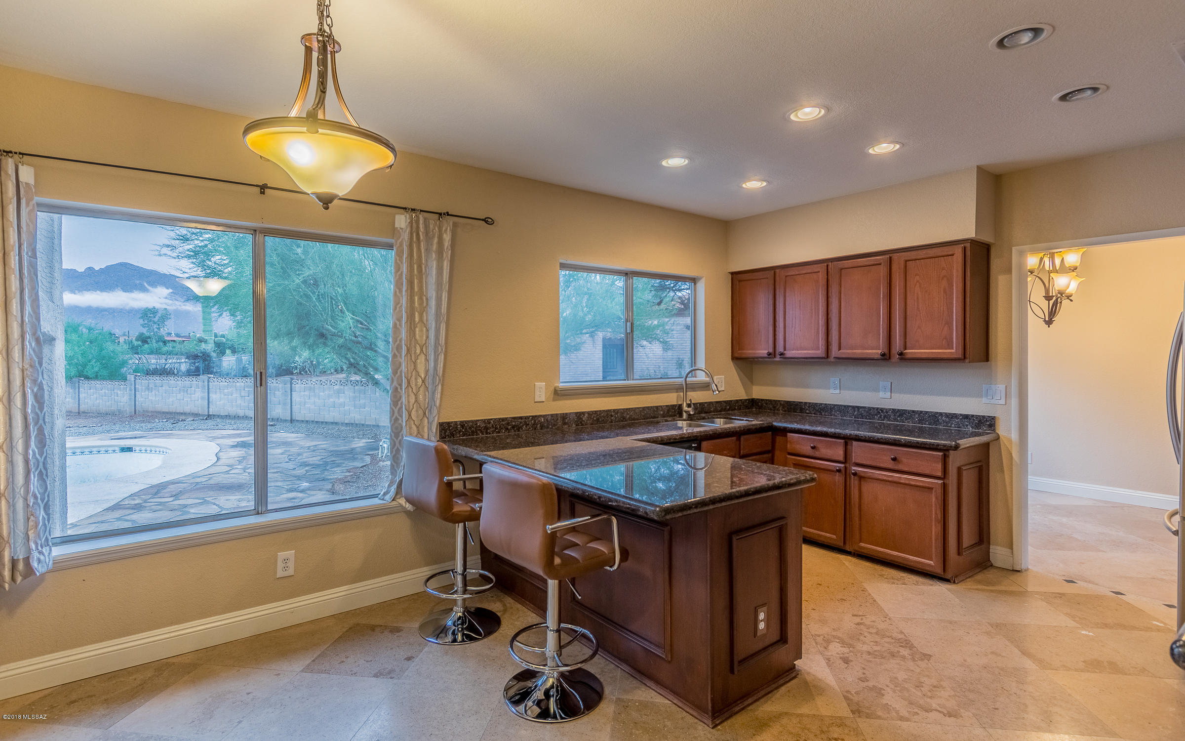 Ready for new homeowners. This sprawling, 2-story plus guesthouse, 6 bedroom/4 bathroom house is tucked away in Shadow Hills with both Catalina Mountain and city views. Balcony off master to enjoy the views of the pool, equipped with slide and diving board. Large fenced yard for pets and kids to roam and enjoy. Separate guest house boasts large kitchen/studio space, plus separate bedroom and bathroom. Storage closet attached. Covered patio leads into downstairs family room with bar and electric wall fireplace. Walk upstairs to the U-shaped kitchen with more views of the mountains and backyard. Step into formal dining and wrap around into formal living. Upstairs you'll find beautiful bedrooms and hall bath. Garden tub in master. Separate shower. Buyer to verify all facts/figs, incl in MLS.