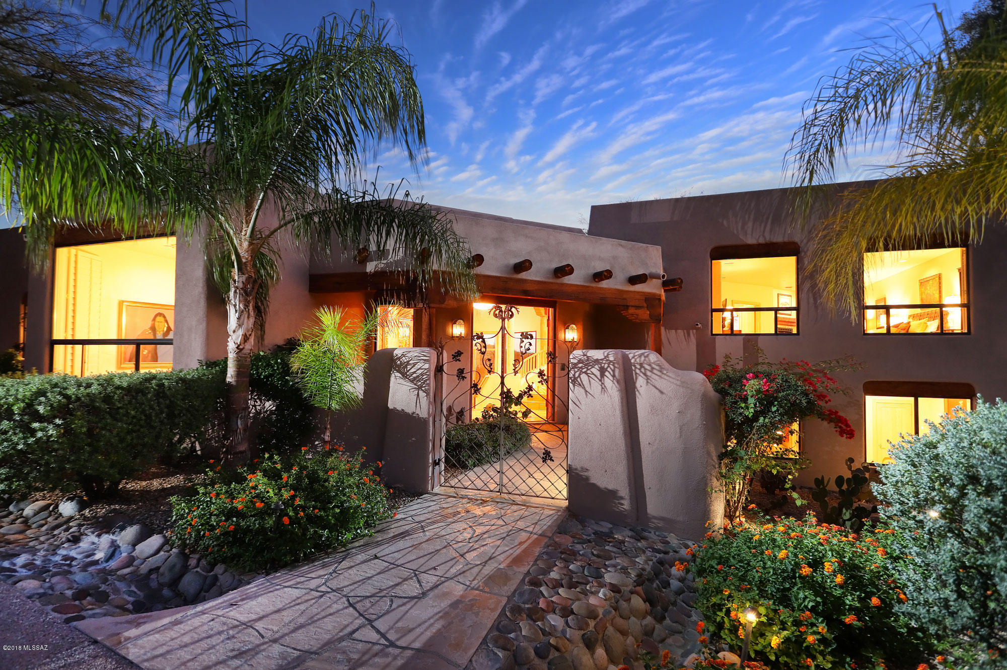 Spectacular contemporary Santa Fe home set high in Alta Vista with awesome mountain and city views! Open entertaining greatroom floorplan with 16 foot ceiling & beautiful beams. Massive covered porch looks out to the pool, spa & city lights. This custom multi level home offer several distinct living areas. Circular aggregate driveway creates a beautiful approach to this fine home. Huge master suite features a sitting area with fireplace and private patio. Master bath includes a walk in shower with dual heads and city views. Generous closet includes separate cedar closet. Lower level includes its own living/ media area, 3 bedrooms & a bath. 3rd bedroom is currently used as an office with unobstructed mountain views.  Artistic details throughout. Oversized 3 car garage with abundant storage.