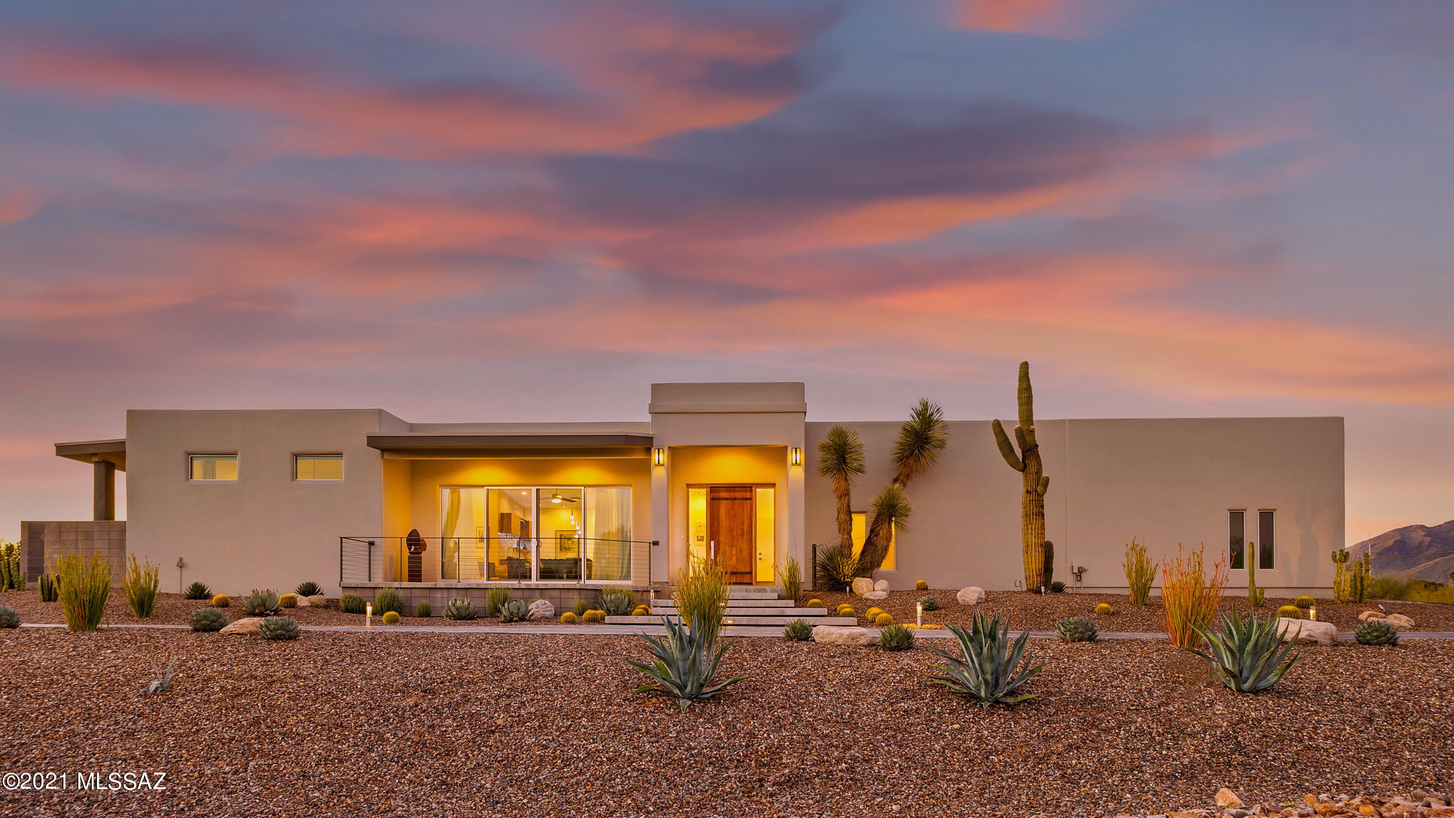 Absolutely stunning, contemporary Foothills beauty with views galore! COMPLETE and professional, top to bottom remodel finalized in 2017- This is not a flip!  Be sure to view the showcase video and floor plan in the links section. 2,891 total Sq Ft, 4 Bedrooms (Owner's suite, 2 large secondary bedrooms and guest quarters), small den/office with closet, 3.5 baths. The finest finishes have been incorporated throughout this home! Custom solid walnut cabinetry with accent lighting, Italian porcelain 12 x 24 flooring, and granite and quartz counters. Featuring a truly gourmet kitchen with large quartz island, built-in electrical/USB pop-ups, high end appliances and mountain views from sink. Enjoy some wonderful sunrises from the front family room with large double slider opening to the entertaining deck. The dining room is adjacent to the family room with wet bar, wine fridge, and up lit shelves.  The great room off the kitchen provides a warm space with large gas fireplace with glass accent pebbles and marble tile surround. The large owner's suite provides private patio, accent windows, large walk in closet with complete built ins, spa bathroom with double sink quartz top, walk-in marble tile shower and soaking tub for two! The 244 s/f guest quarters can be used as bonus space, visitor suite or special care suite with automatic push-button door and wheelchair ramp into garage for easy access, roll-in shower, vanity, mini fridge and separate cooling/heating.  Full laundry room/pantry/mud room with entrance from garage. Amazing mountain views from the large backyard featuring expansive covered patio, outdoor kitchen with grill, side burner, sink and granite top, TV, accent lighting, custom metal gates, concrete city and sunset view deck with built-in gas fire trough and custom planter.  3-4 car garage with sink, multiple upper storage racks - 3 Bays: 2 @ 28 feet, 1 @ 20 ft deep with Master Cool Swamp services. New sewer, plumbing, gas and electrical service throughout house. 2 instant hot water heaters and an Enviro Water purification system. Dual zone  2 Trane AC/Heat pump. Surround sound audio throughout including patios with ceiling speakers, wired for Cat5 and Internet in all rooms. SimpliSafe alarm system on all doors and windows. Brand new roof with hose bib and electrical outlets around exterior of roof. Paved circular driveway, ground lighted RV/Trailer parking spot.  180 Degree Mountain, Sunset and City views...in the center of town with access to all of Tucson.