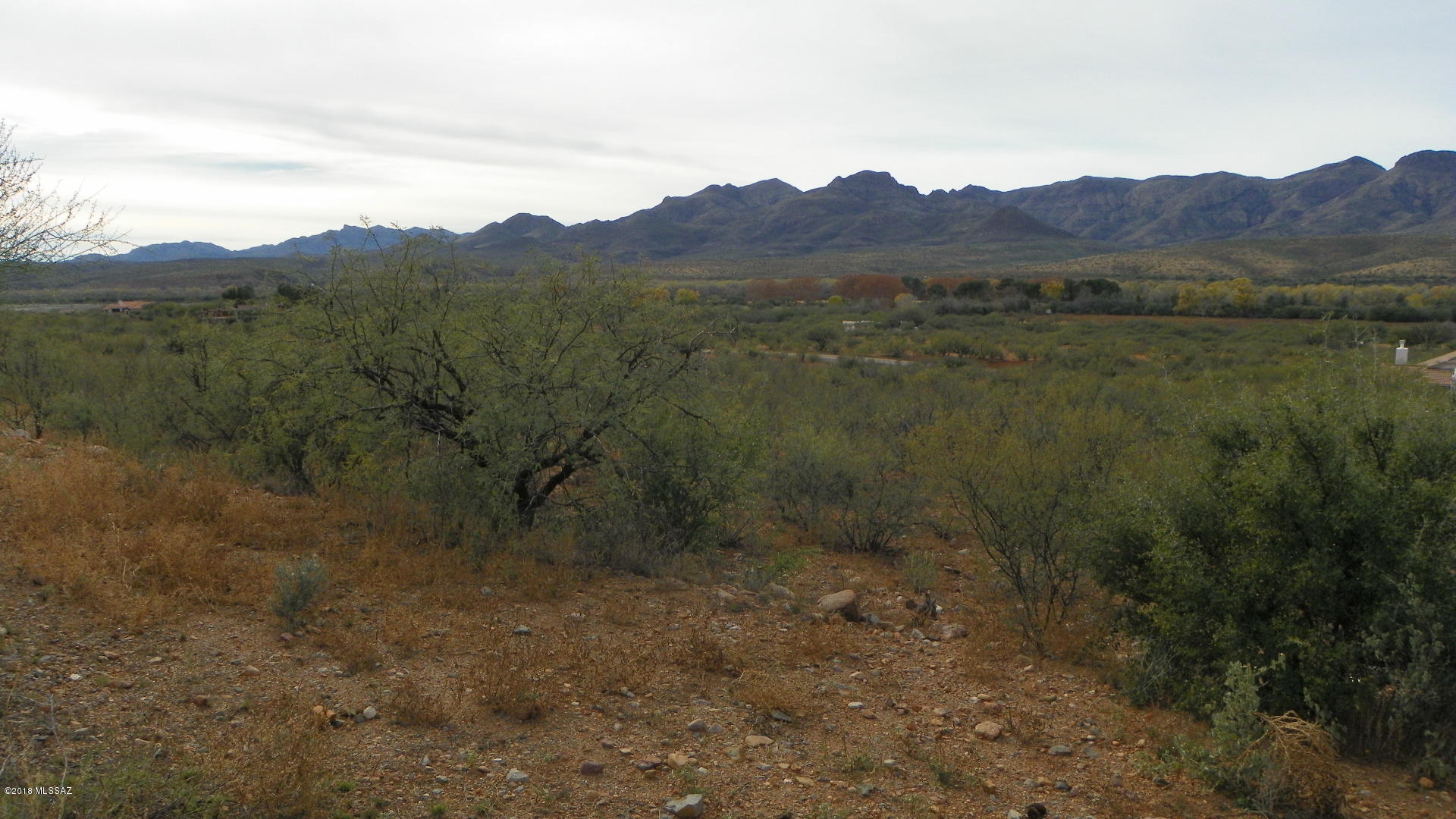 Residential lot with flat area for a house to be built.  Close access to Interstate 19.  Electric and water appear to both be at the street.  Fantastic Mountain views.  Two lots have been combined to one parcel.  Great location!