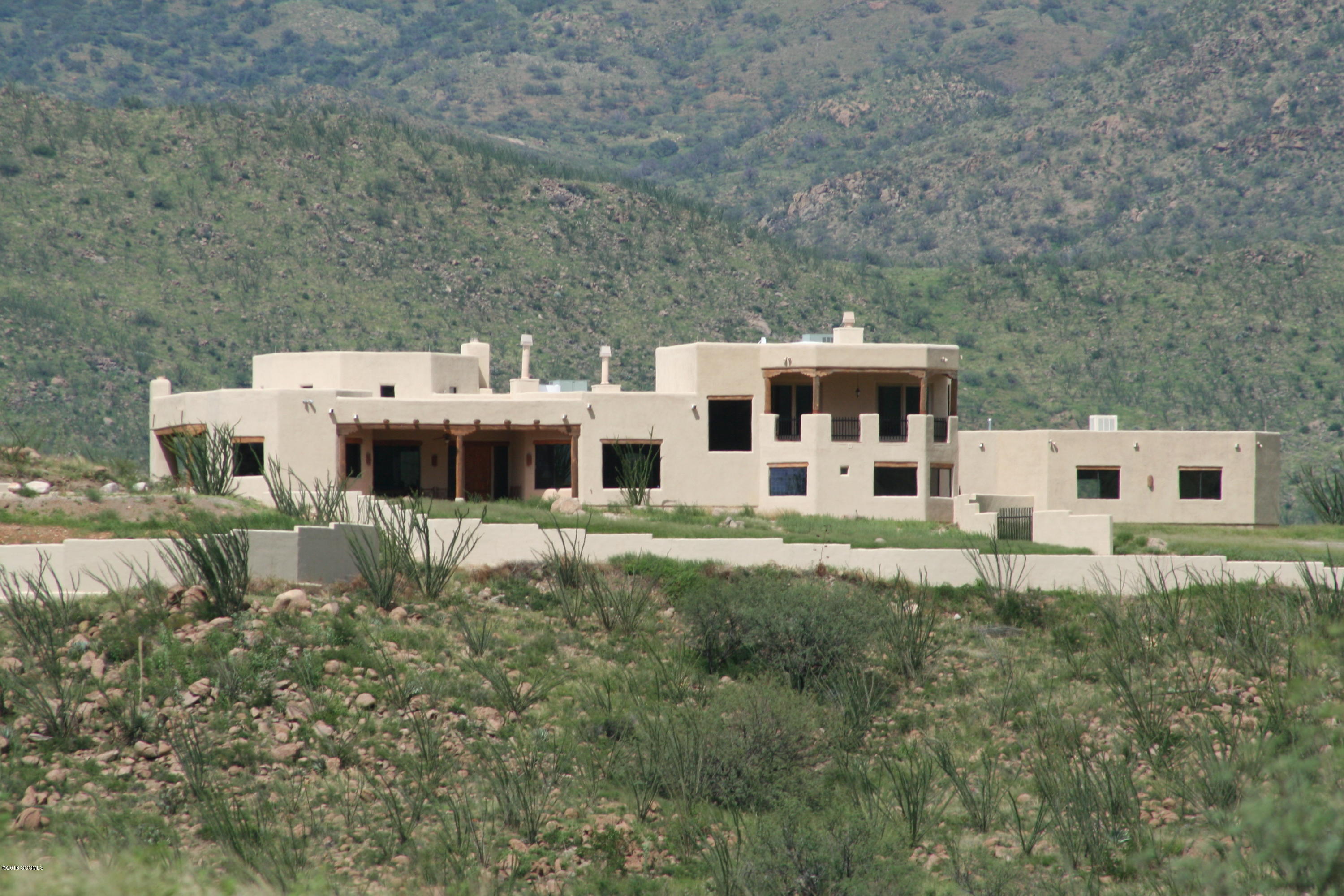 Sensational large custom home on 77 acres built on a hill with 3 BR & 4 BA with office/library and media room. Incredible 360 degree views with 1/4 miles on Bond Canyon Creek Riparian area below the home. Awesome views from every window! 4,800 sq ft in the home and 2,900 sq ft in a heated & cooled 6 car garage. 7,700 total square feet plus very large porches with an outdoor fireplace. Pool, spa, BBQ, helipad, seasonal creek, private well house, 2 electric gates all on 77 acres. Excellent value!