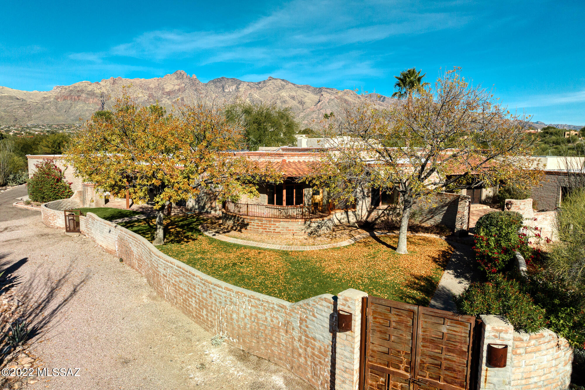 Charming hacienda style home in the heart of the Foothills. Expansive outdoor living areas, majestic panoramic views, tranquil courtyards, stunning sunset patio views. Spacious home with Joesler like design, exposed beams, private office, dine-in kitchen with matching stainless steel appliances and sub-zero refrigerator and freezer. Charming primary bedroom with beehive fireplace and private backyard access.  Primary bath with soaking tub, rain shower head, and dual marble-topped vanities.  Perfect for families, spacious kid wing with lounge, 3 bedrooms, unique 3 sink vanity bathroom.  Private guest quarters with separate bath and entrance to pool.  Resort style outdoor living, oversized pool, expansive patio areas, outdoor kitchen and fireplace.