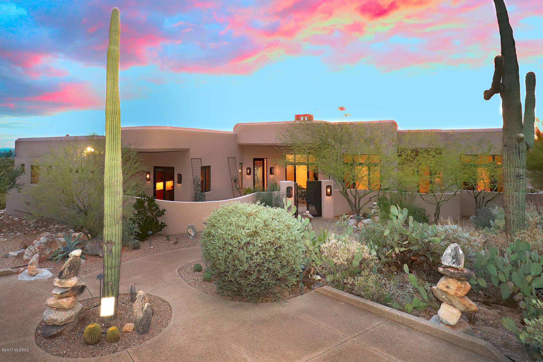 The discerning Buyer will find 7789 N. Canyon Spirit Way sited on 1.12 acre corner lot to be one of the premier soft contemporary homes now available in prestigious gated Pima Canyon Est. Entering through artistic metal front door, guests are initially greeted by an open floor plan w/NO interior steps that inspires entertaining with a perfect flow between living room, dining room, fully appointed kitchen & tranquil outdoor living spaces.  Impressive Master Suite feats FP, dual walk-in closets w/private laundry,soaking tub,rain shower & private entrance to outdoor patio. A sleek streamline gourmet kitchen awaits you w/SS appl.,granite counters,center island,cherry cabinets & oversized butler's pantry. Enjoy expansive mtn views from office with built-in cabinets. Your contemporary retreat!