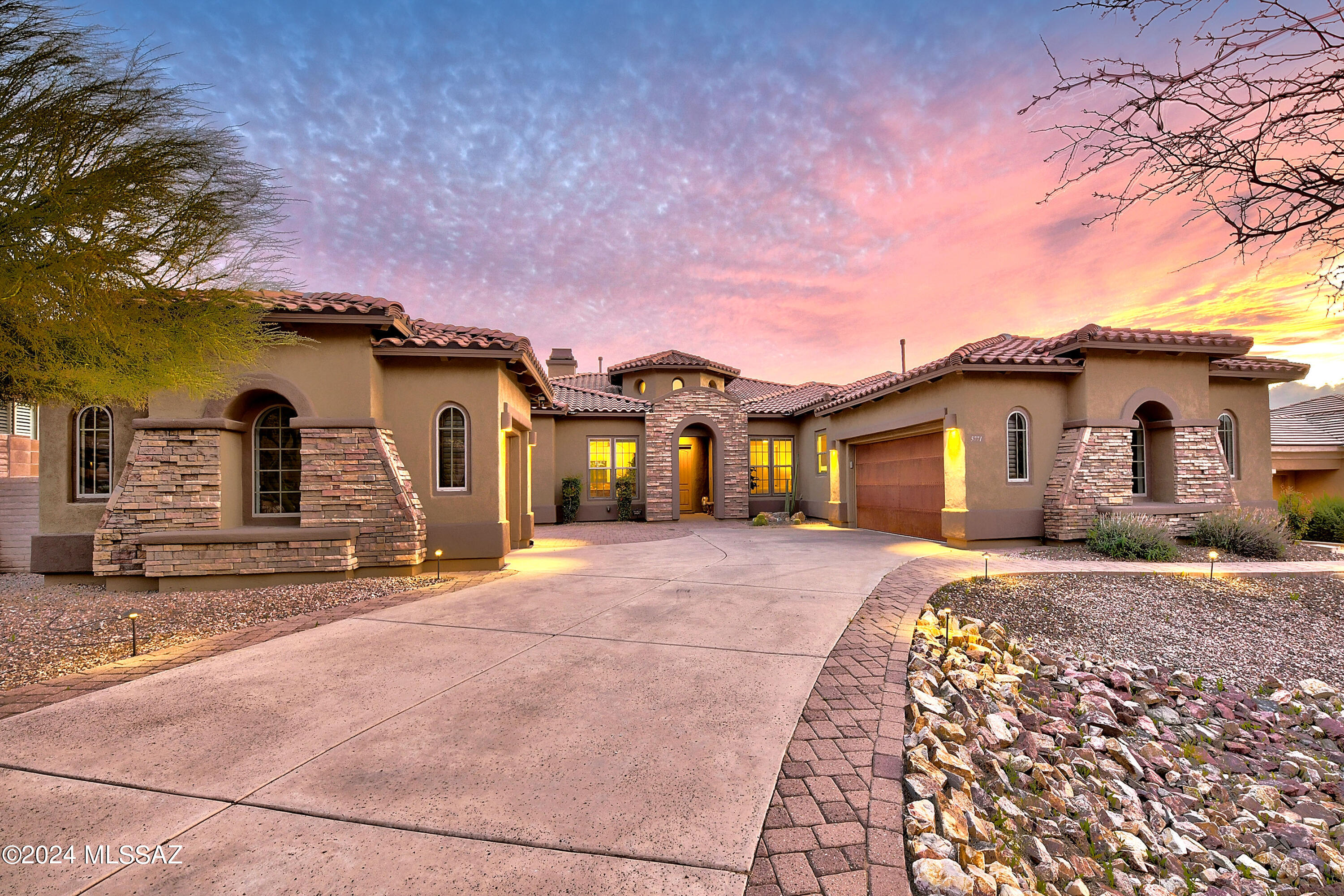 Welcome to this Elegant 4-bd/3.5 ba Tolls Brothers gem featuring timeless architectural design situated in the prestigious gated community of Solana in Dove Mountain.  Indulge in the ultimate desert lifestyle bringing Serenity and Elegance nestled on the 11th hole of the lush Gallery North Course. A premium .45-acre cul-de-sac lot with a South facing exposure showcasing amazing sunsets. Step into a world of refined luxury as you explore this spacious 4,103 sq. ft. home showcasing meticulous attention to impeccable craftsmanship throughout.  
The luxury of this home will not go unnoticed, featuring a striking facade with stone and accents.  A Breathtaking entrance showcasing walls of windows bringing in an abundance of light. Spacious dining & living areas for entertainment and enjoyment stone fireplace, neutral tile flooring, modern light fixtures, new carpeting, new Hunter Douglas blinds, water conditioning system throughout, recently updated guest bathroom showers and the list goes on. Chef's dream kitchen with wood cabinetry, crown molding, granite counters, tile backsplash, updated stainless steel appliances, dual wall oven, a two-tiered island with breakfast bar, and breakfast nook. Breathtaking primary wing with golf course and mountain views and own private access to patio, 2 walk-in closets.  Primary bath includes dual sinks, ex-large shower w/sitting bench, makeup table, & a soaking tub. Three guest bedrooms, one as an ensuite, plus a den, office or even a 5th bedroom!
The amazing backyard offers direct gate access to the golf course and includes a covered patio with power sunshades to create your own outdoor gathering space, extended flagstone seating areas, a built-in BBQ, outdoor fireplace, fire pit, putting green and view fencing. Residents of Dove Mountain have access to memberships that include multiple world-class golf courses, pools, gyms and restaurants nestled within this striking community.