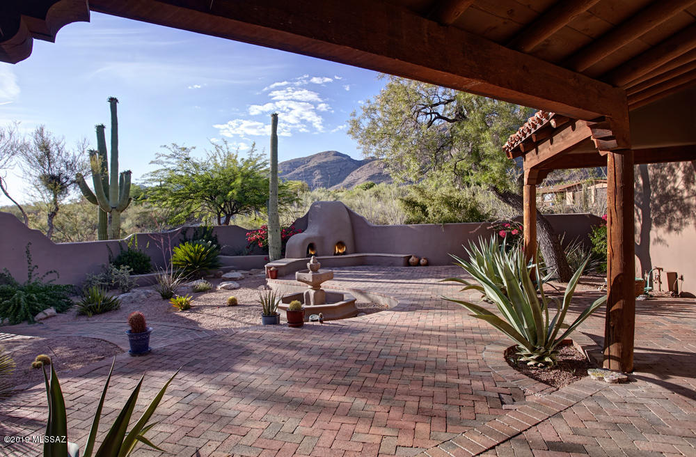 High in the Catalina Foothills on a Large Private lot at the end of a cul-de-sac :  2 minutes from Skyline/Campbell - Short Walk to Manzanita School : Adjacent to the Giant Campbell Wash : Extraordinary Mountain, City & Sunset Views, truly Extraordinary! : An Attractive and Very Comfortable Sante Fe with Gorgeous Areas for Easy Enjoyment of Indoor-Outdoor Living : Large Kitchen Open to Spacious Family Room- both are adjacent to Large Covered Patio for All Day - All Night Recreation, Relaxation, Fun & Dining : Spacious Master Suite - Large Bedroom with Fireplace + Extra Room that could be Exercise, Office, or... +  Private Bath with Mountain Views & Large Walk-in Closet : 3 Additional Bedrooms & 2 Baths : 3 Car Garage : Gorgeous Pool & Grounds: Move-in ready. Don't miss the drone footage