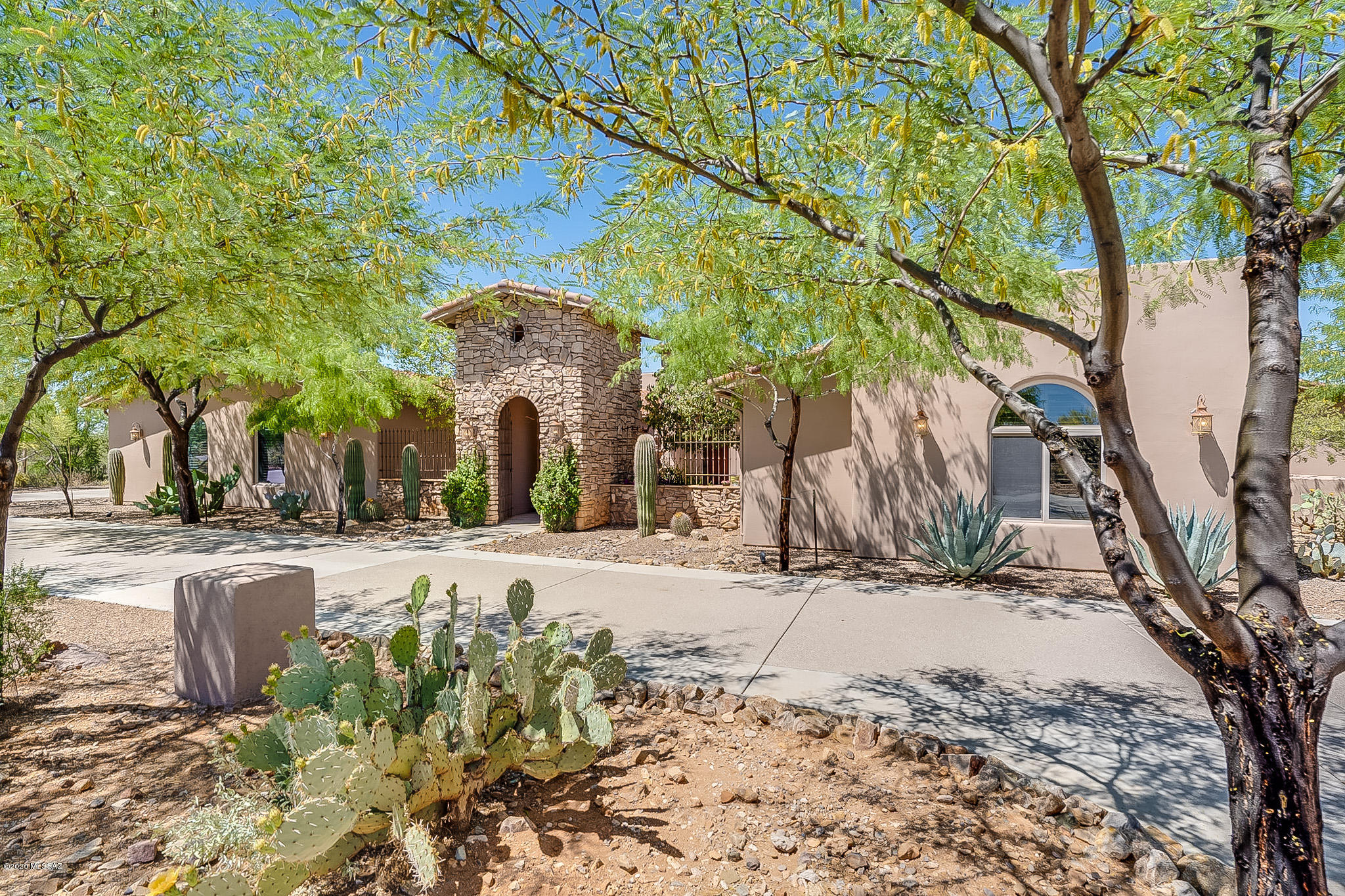 Resort-like setting, spectacular 5bd/5.5ba on 3 acres ready to call home! Circular drive leads to welcoming gtd crtyd w/fountain, fp, sitting area & gst house w/kitchenette & bath. Inviting entry opens to great rm w/ fp, easily flows to gourmet kitchen beautifully equipped w/granite counters, Viking appl, butler's pantry, wine fridge, bkfst nook. Escape to jaw-dropping designer landscaped bkyd w/expansive cvrd patio, add'l grilling gazebo, turf, huge sparkling pool w/fountain, lagoon, diving brd & slide. Concrete flrs lead thru 5808sqft, split bdrm to dining rm, ofc w/dbl desks & built-ins, grand mstr suite w/exercise space & sitting rm, lg laundry rm & giant bonus rm w/ 3/4ba, full wet bar & access to magnificent east-facing yd w/panoramic views of Tortolita & Catalina mtns & cityscape.