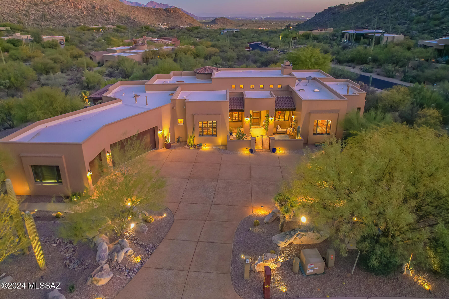 Enjoy panoramic mountain, valley and Tucson city light views from this Custom Luxury Estate nestled within the exclusive, guard gated community of Canyon Pass at Dove Mountain. This 4BD/4.5BA (3,930 sq ft) residence on a large, corner cul-de-sac lot blends Southwest charm with modern convenience. Gated courtyard with a Tortolita Mountain backdrop provides private access to attached Casita. Enter this stunning home to find a formal living space with soaring wood beamed ceilings, media wall with floor-to-ceiling stacked stone fireplace, chiseled edge Travertine and wood plank flooring, rich hued cabinetry, wood shutters/blinds, plus clerestory & picture windows. Spectacular gourmet kitchen with light filtering skylights boasts a central island with Spekva Iroko wood countertop bar, a casual living/dining area with domed ceiling over wet bar, luxe granite countertops, new stainless Thermador refrigerator/freezer, Viking 6-burner gas cooktop/ovens/warming drawer, dual dishwashers, wine cooler, Blanco granite composite sink plus walk-in pantry and walk-in storage closet off hallway. Striking Owners Suite accesses rear patio and offers an updated bath hosting split dual vanities with Quartz counters, dual custom closets, freestanding soaking tub, tiled rain head shower with body jets, plus SunTouch heated porcelain floor. Two additional en suite bedrooms off front/rear patio (one used as office/one with pool access) plus powder room and spacious laundry. Additional amenities include zoned heating & cooling, central vacuum, water softener, indoor/outdoor wired sound, security system plus attached 3-car garage with storage cabinets. Retreat to a tranquil rear setting boasting dual wraparound patios, heated Pebble-tec pool with raised spa waterfall, grill station with beverage fridge & bar seating, plus outer patio and view fence. Enjoy wraparound views of the Tortolitas plus sweeping mountain and valley views beyond. Dove Mountain is home to the Ritz-Carlton Resort, Gallery Golf & Sports Club, The Golf Club at Dove Mountain, several parks plus hiking/biking trails. Perfect for the most discerning buyer!