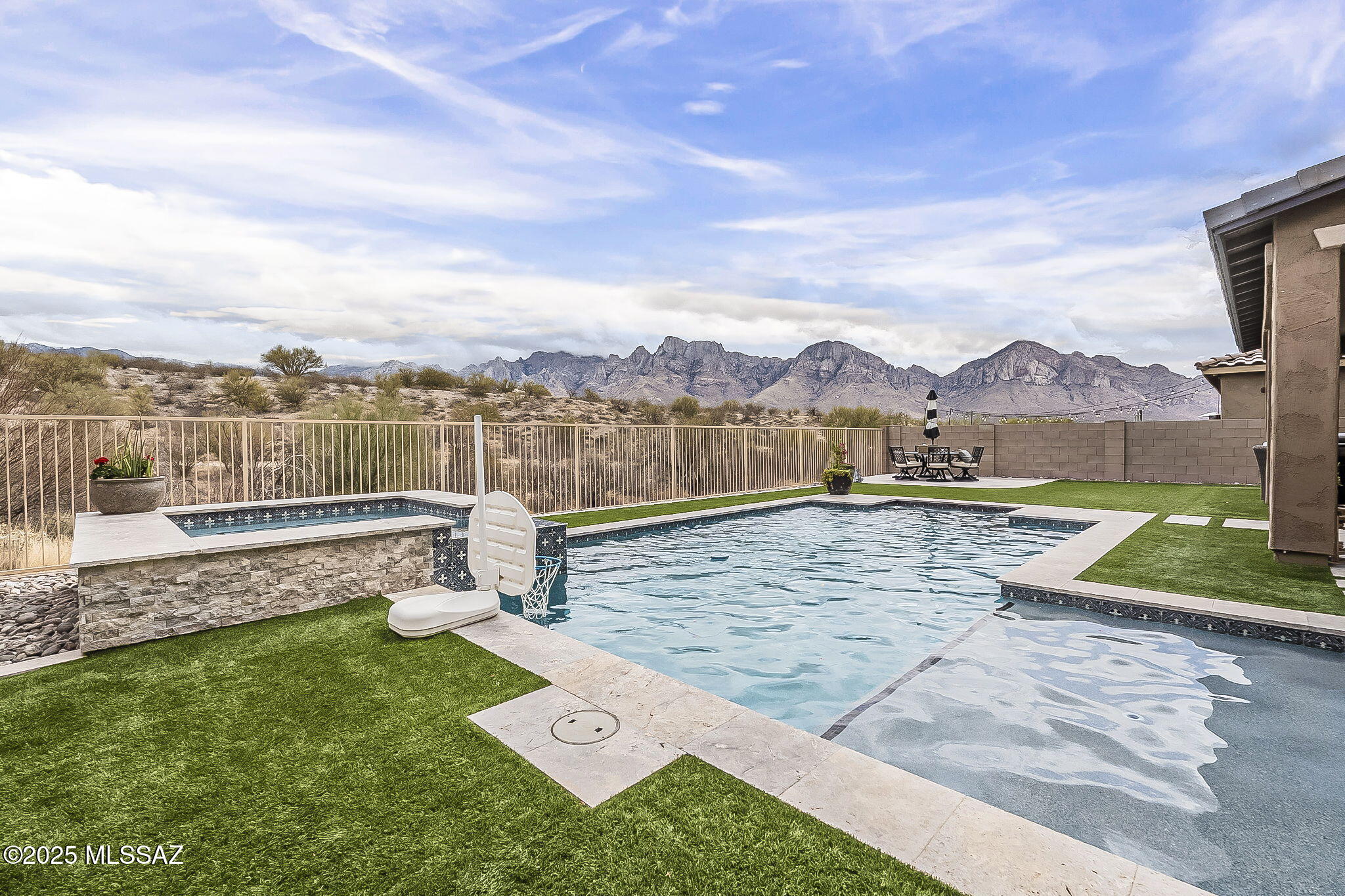 This stunning new home is nestled in a private gated community in the highly desired Silverhawke neighborhood.  Your new home backups up to natural desert landscape and features some beautiful views of the Mountains.  Your homes designer finishes include; a travertine cool deck encircling a heated pebbletec pool & spa. soft low maintenance turf, stacked kitchen cabinets, designer flooring, and a built-in linear fireplace.   Your upgrades include a massive two-person shower, separate his and hers closets in the primary, a mudroom, massive prepper's pantry, and a large loft.  Your new home is located close to the highly desired shopping, dining, recreation, and medical facilities found in Oro Valley.  We prepped for your arrival with some fresh paint and cleaning. This is the ultimate family and entertaining home.  Only when question remains to be answered.  When do you want the keys to your new lifestyle?