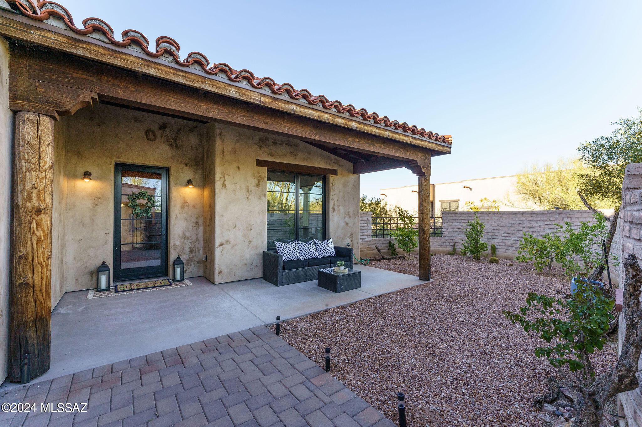 Let this charming enclosed courtyard greet your guests or give you the solitude and comfort after a busy day. Enter your grand foyer with the old world charm reflected in the masonry work of the arched entry with accent lighting. Truly an experience of how this home will make you feel. Through the arched entry you will find comfort in your open great room plan with cozy fireplace, spacious dining area and large gourmet kitchen. So many memories to be made around the large island as you create special meals for family and friends. The three bedrooms  include their own en suite with an additional powder room for guests. The Primary Suite is your Haven split from the other bedrooms with views to the back of the home. It offers an incredible en suite that will make you feel like you are at your own private spa. Home is 2859 sq. ft. with easy care, stained concrete floors. An additional den will give you that flex space you desire. This private .45-acre lot is surrounded by the desert flora and fauna and offers you a pool with lagoon and swim up bar stools and includes ambience lighting. Built in 2018 with the Character and Charm that calls you home to the Sonoran Desert.