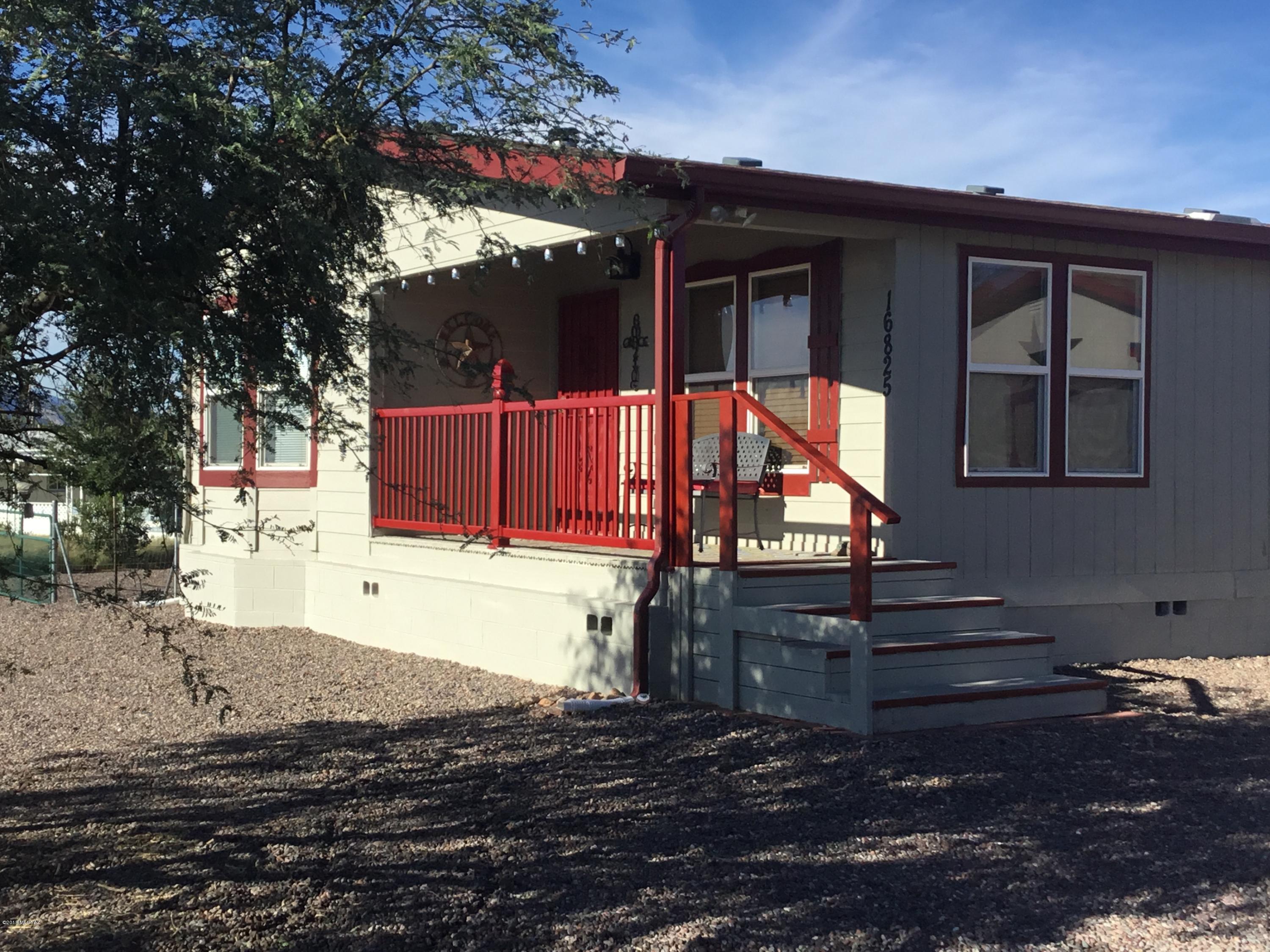 Charming Manufactured Home just off the J6 Ranch/Mescal Exit! Well-kept approx. 1920 sq. ft. home with beautiful views. 2 BR/2 BA with den or easy conversion to a third bedroom. Large two bay garage with drive-through access to backyard. Washer and dryer hook up in garage with both electric and gas. 1.03 acres and room for any additions you desire. Great outdoor living in backyard. and porch area. Large kitchen with island and backdrop. Lots of storage space.