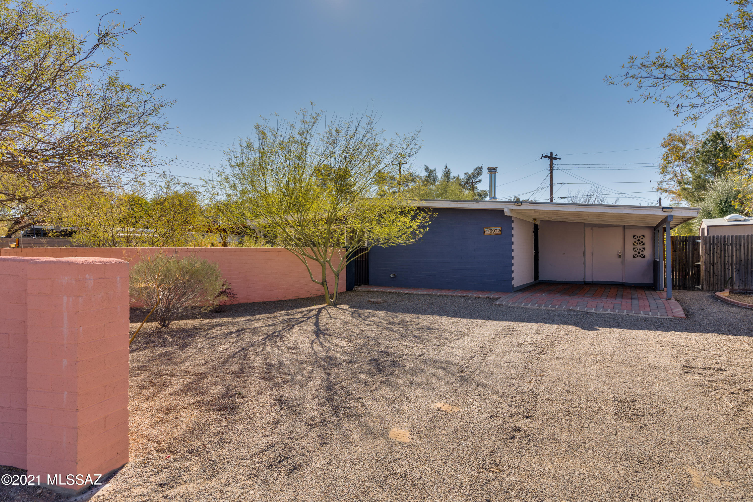 Mid century modern with tile and laminate floors throughout! Fresh new interior paint! Open floor plan with Living & Family Rooms! Bright open Kitchen with double stainless steel sink and electric oven/stove! Moveable island stays! Three Bedrooms and one Bath! Newer walk-in shower, new mirrors and lights! Laundry closet with washer! Covered porch with steam room! Large .25 acre lot with 2 sheds and raised planters as well as a covered patio off the Family Room! Backs up to Villa Serena Park which offers picnic table, playground and plenty of room to roam!  Call today for your private showing!