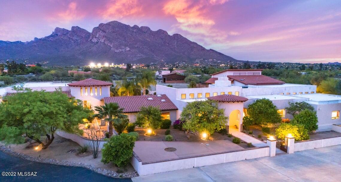Back on Market-Buyer's Financing fell through.
When Arizona Inn merges with Hacienda del Sol you get this incredible Mediterranean-style home Updated Oro Valley 7,954sf 7BR/7½BA w/office, activity room, exercise room, sauna & 4-car garage. Includes 874sf 1BR/1BA guest quarters & 894sf 2BR/1BA guest suite w/private entrances. Pergola connects 2,060sf fully equipped 2BR/2½BA+den guest house w/private entrance w/1 car garage. All situated on 4.7acres w/spectacular Catalina Mountain views & incredible sunset & sunrise displays. Gated courtyard entry w/fountain. Top-of-the-line appliances, 2nd Kitchen/Butler's Pantry, Media Room/Activity Room. Great room has beautiful Cantera stone floors, floor/ceiling windows & stacked rock fireplace. Recently remodeled upper-level Master Suite has sitting area w/new flooring, lighting & wraparound deck w/wrought-iron railing. Luxurious spa-like bath has freestanding bathtub, separate walk-in glass shower w/rain head, floating vanity w/double vessel sinks, deluxe round mirrors & lighting & large custom designed walk-in closet. 800sf 6 stall barn w/corral. Equally beautiful landscaping enhances inspired Mediterranean style w/Pool/Spa. Just minutes away from hiking, biking, golfing, tennis, Catalina State Park, shopping, dining, theatres, fitness, parks & health care & a short drive to downtown Tucson, historic 4th Avenue & UofA. No HOA. Horses Allowed.