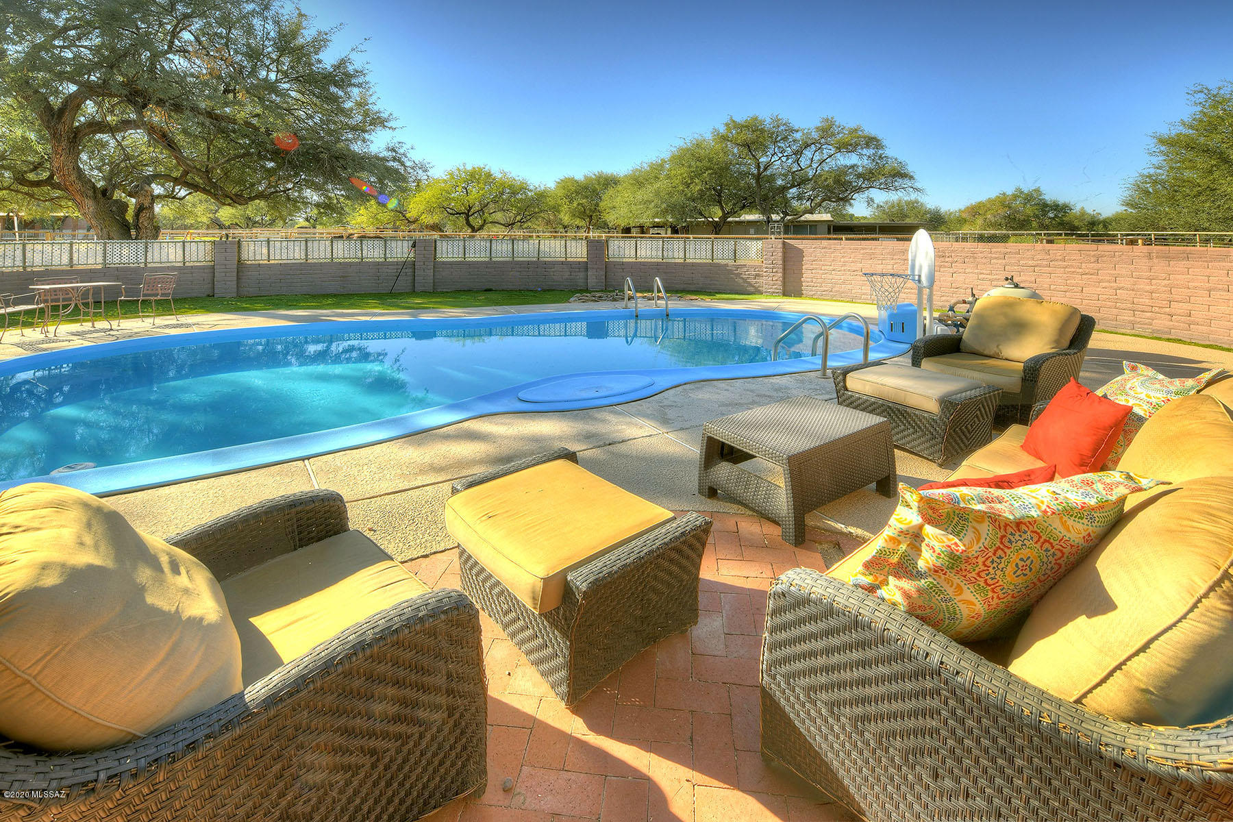 Fabulous 3.34 acre equestrian estate on prestigious Woodland Road, an oasis in the desert, and known for upscale ranch-style living & bird watching. The 2481sf home w/sparkling pool & mountain views is surrounded by grass & mature mesquite trees maintained by private well. Spacious kitchen opens to dining room w/wood burning FP. Saltillo tile flooring & unique built-ins provide charm. 400sf bonus room off master suite w/separate entrance makes great office or studio. Home can be sold furnished. Horse facilities feature 2300sf of covered barn area, room for 9 horses, 2 pens, lighted arena, huge tack room & direct access to wash for trail riding. This location feels remote yet convenient to shopping and restaurants. A home on Woodland Road is more than a house, it's a lifestyle.