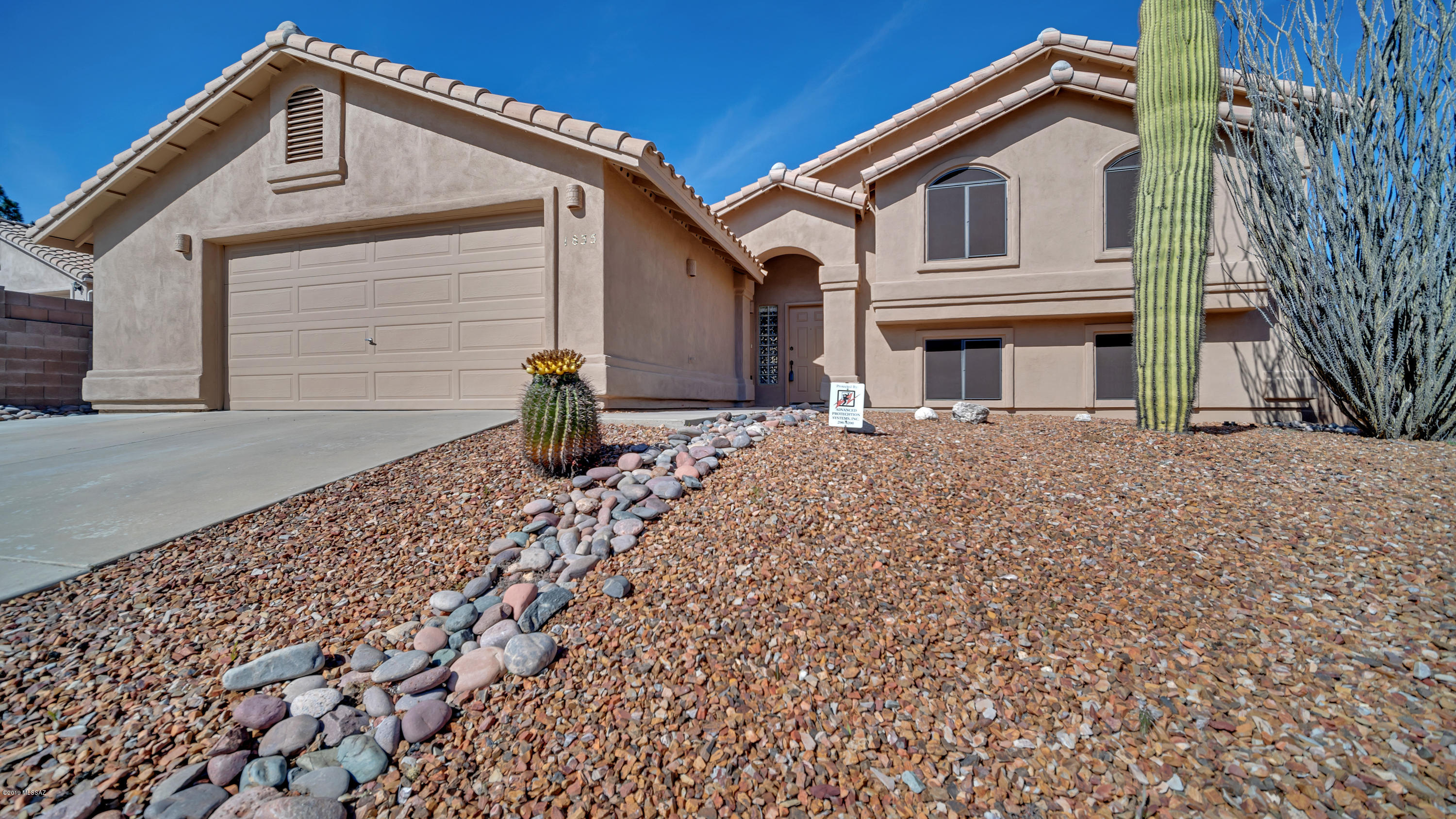 Nestled in desirable Oro Valley, indulge in sophisticated southwest living in this meticulously-maintained five bedroom, three bath home boasting high ceilings and broad windows with magnificent views. This 2,440 square foot split-level floor plan is ideal for entertaining with a roaring great room fireplace and arched door entry into the bright formal dining area. The eat-in kitchen offers plenty of storage with ample cabinetry, large pantry. Laundry room includes front load washer & dryer. Relax in the spacious master suite featuring a walk-in closet,  en-suite- bath with executive height vanity, dual sinks, walk in shower and lovely jetted tub. Enjoy a fully-appointed home theater with Panasonic projectors, 142'' fixed projection screen, surround sound, 3D technology Enjoy beautiful mountain views from your covered and uncovered patio areas.  This incredible home offers southwest serenity at its , finest.  Original owner has meticulously maintained this home, you will not be disappointed.