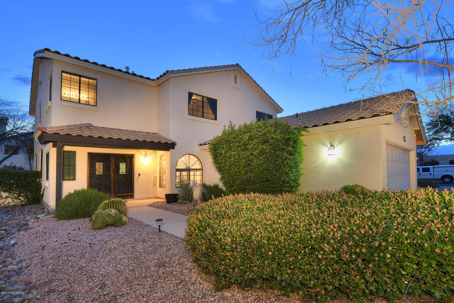 This ''Light and Bright''  2524sf Gorgeous Contemporary with 4 Bedrooms & 3 Baths and refreshing POOL is MOVE-IN Ready!  TERRIFIC Open Floor Plan w/High Ceilings, Inviting Family room w/cozy gas Fireplace, Separate Formal Dining room & Living room. COOK's Kitchen has newer Stainless Steel Appliances, breakfast bar, pullout drawers, Corian countertops & separate panty. Luxurious Master Suite boasts Dual Vanities, Walk-in Shower, Large Garden Tub & Plenty of CLOSET space! Resort like backyard with Sparkling Pool, enclosed AZ Room, flagstone patio & Citrus Tree is a True SANCTUARY. MOUNTAIN VIEWS from the front of the home. Two car garage has workshop/storage area- with handy sink. This home has it all w/GORGEOUS Plantation Shutters, Designer Paint & Ceiling fans. Welcome Home!